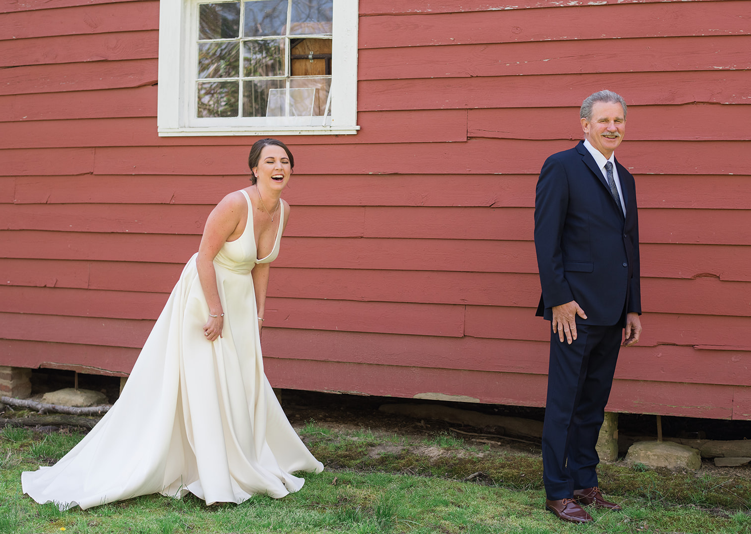 bride smiles as she is about to do her first look with the father