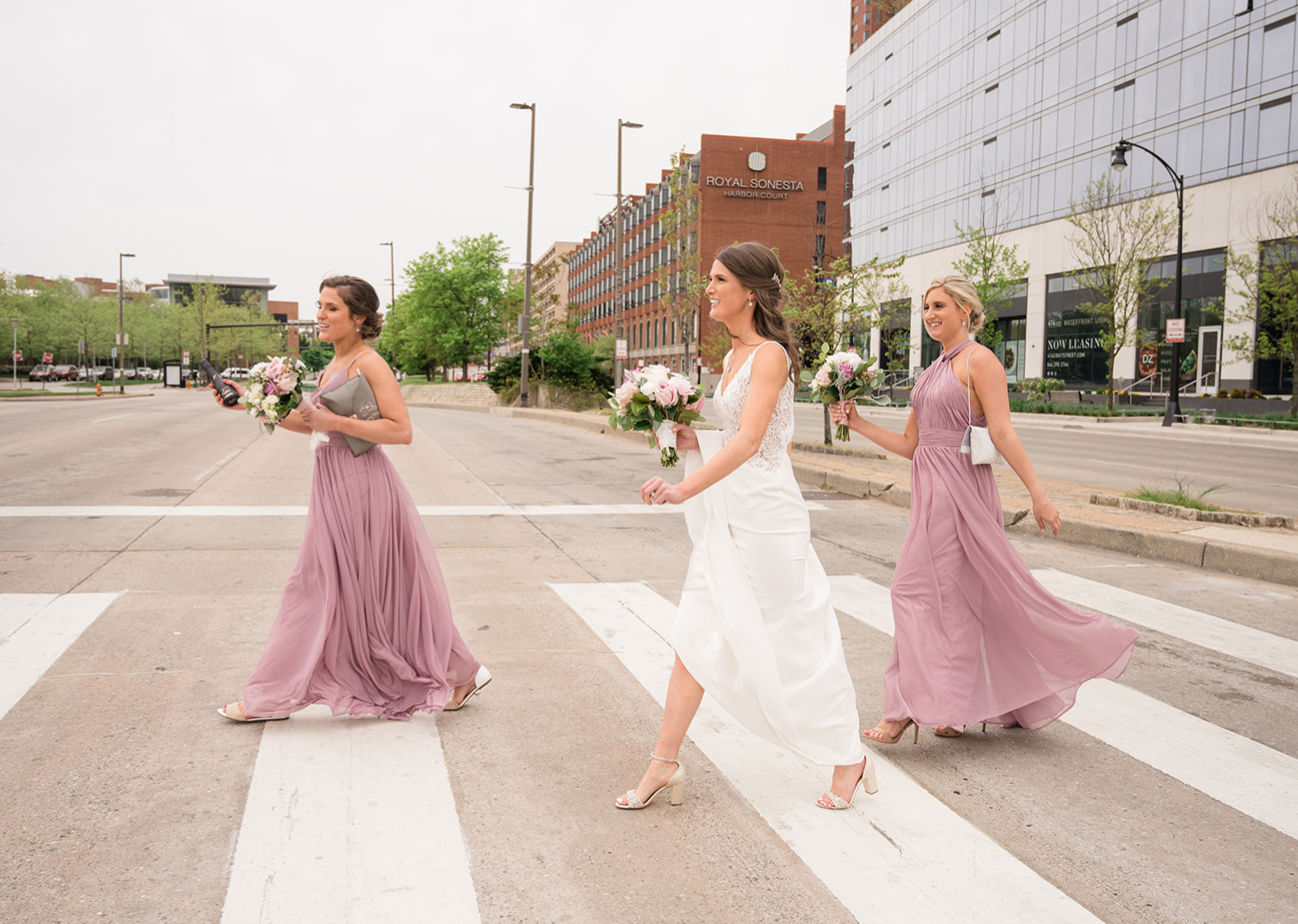 bridesmaids and bride crossing the street in front of the Belvedere Hotel