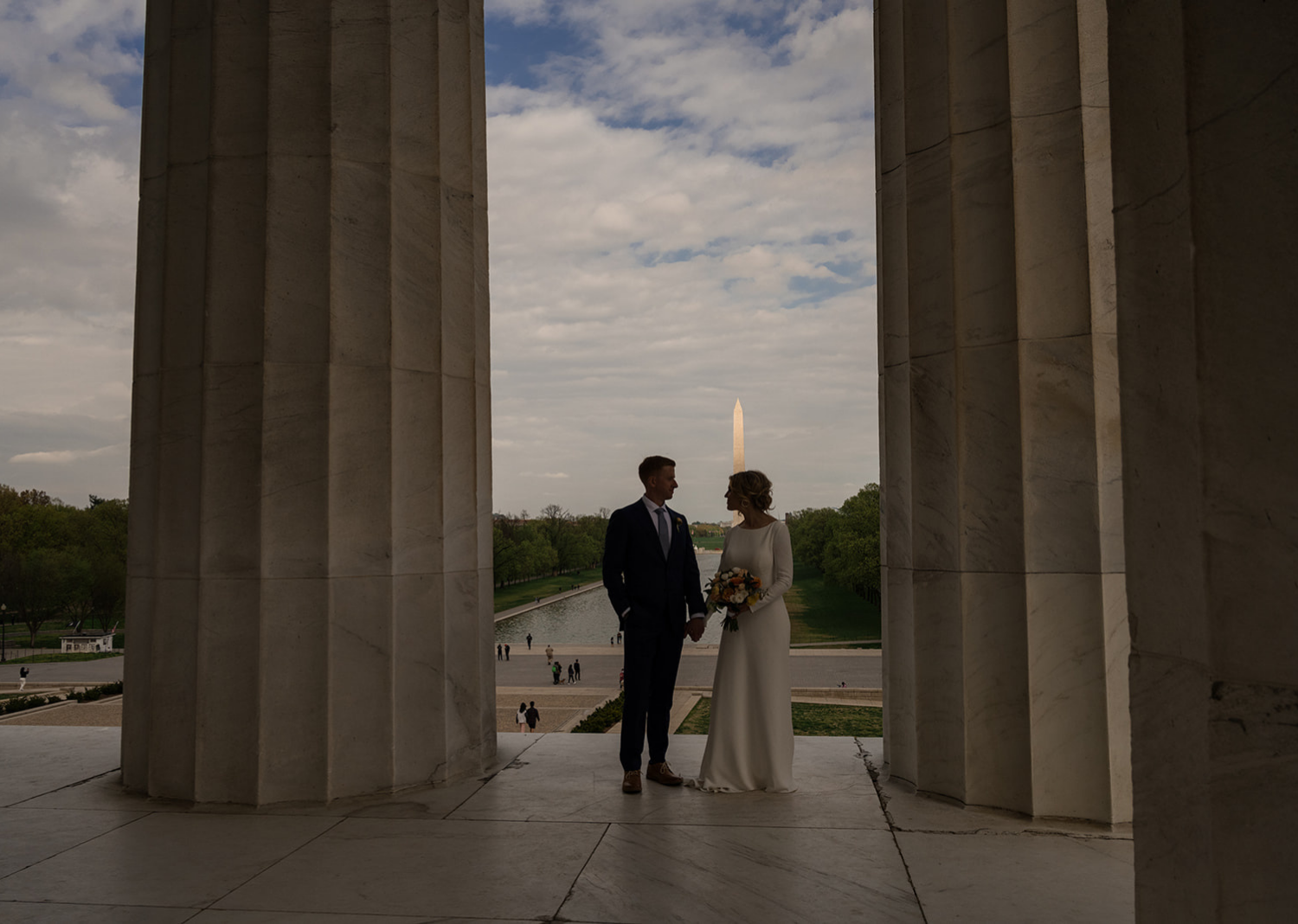 bride and groom pose at the Lincoln memorial