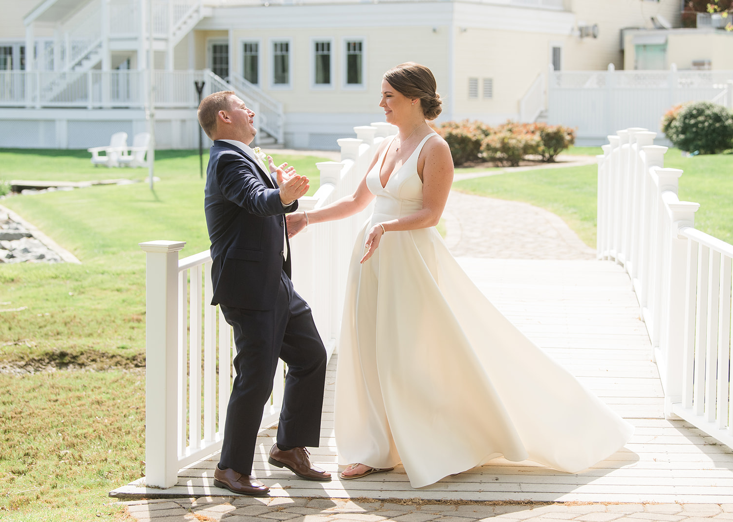 groom smiles as he sees his bride in her wedding dress for the first time