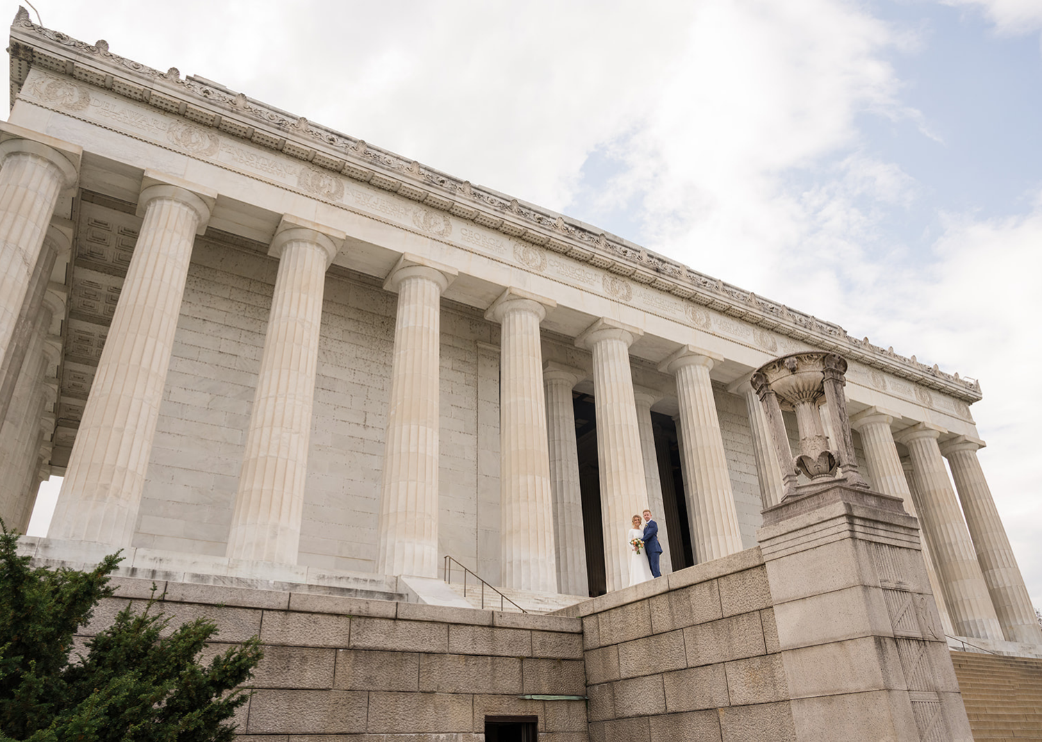 bride and groom posing in front of the lincoln memorial