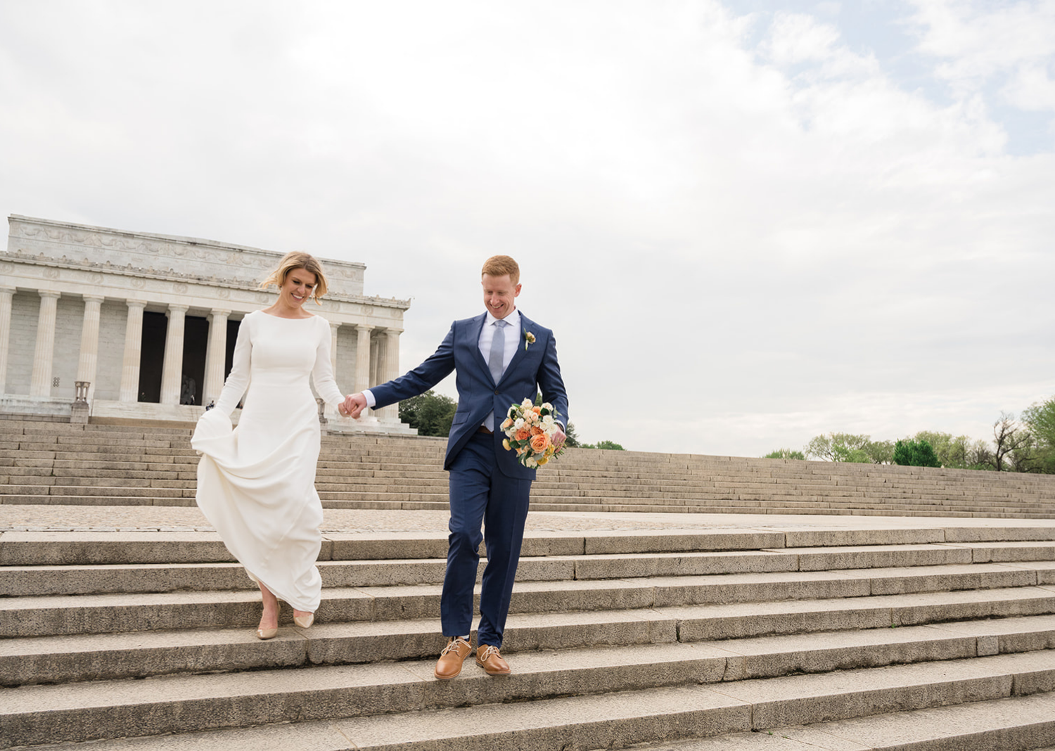 bride and groom run down the steps of the lincoln memorial