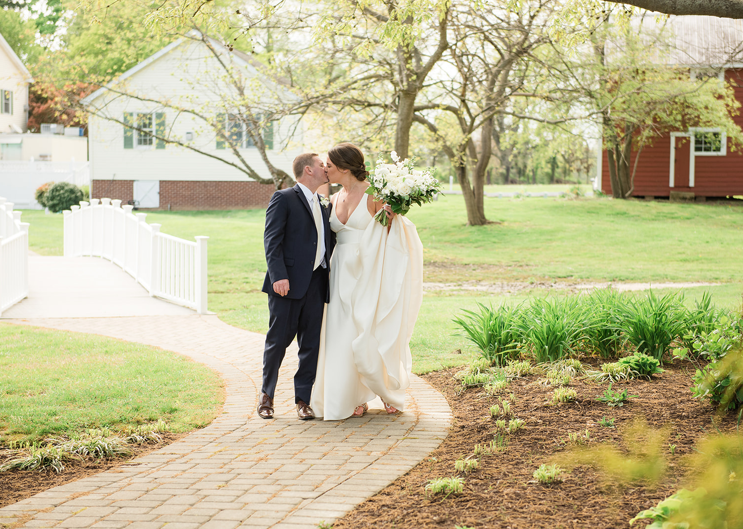 bride and groom share a kiss as they are walking to their wedding ceremony