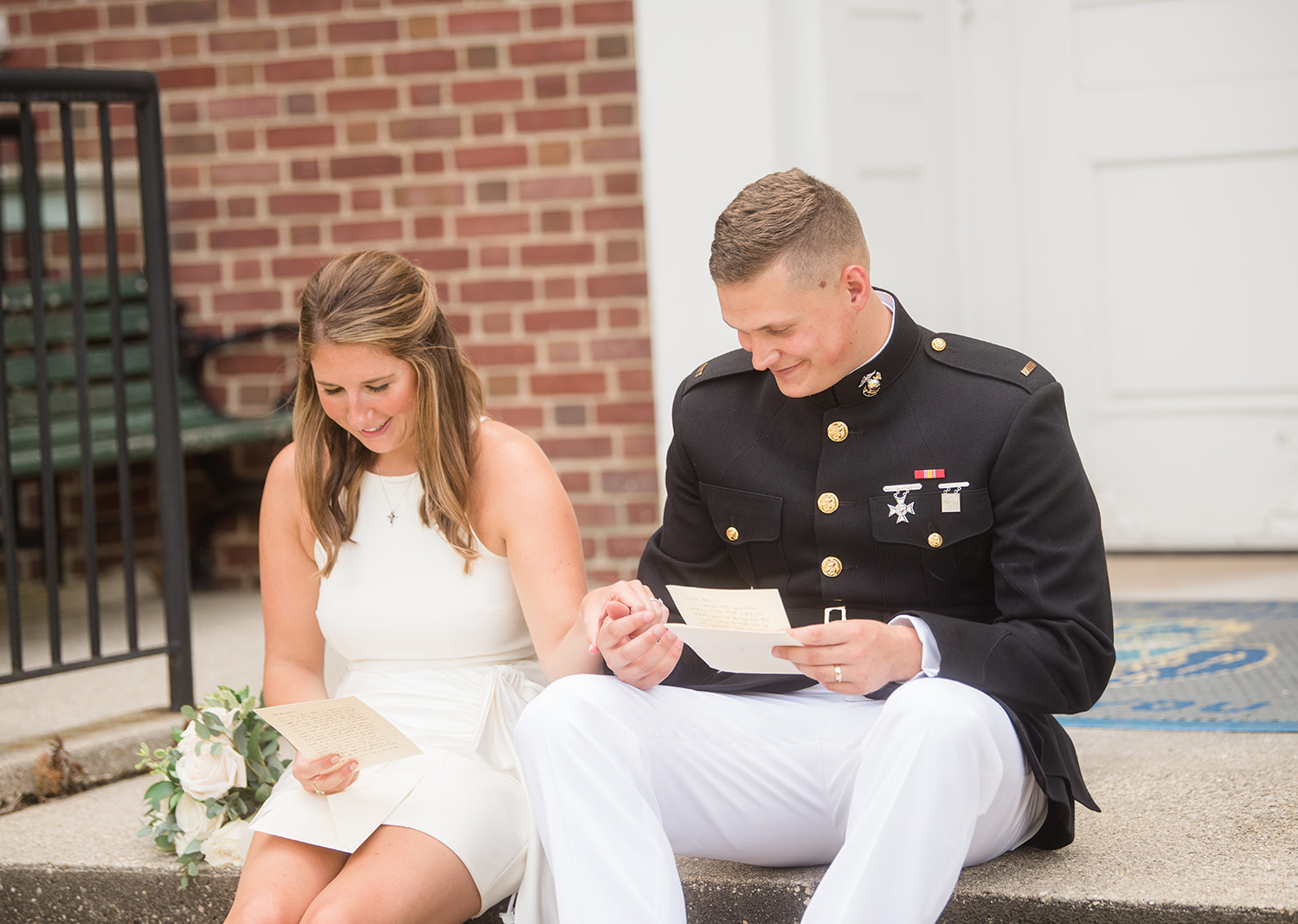 bride and groom reading letters they wrote to each other for their elopement day 