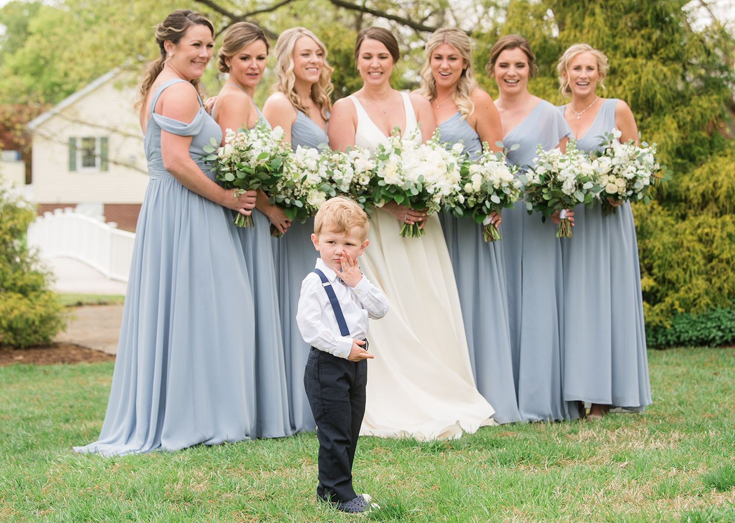 bride smiles as her bridesmaids gather around her