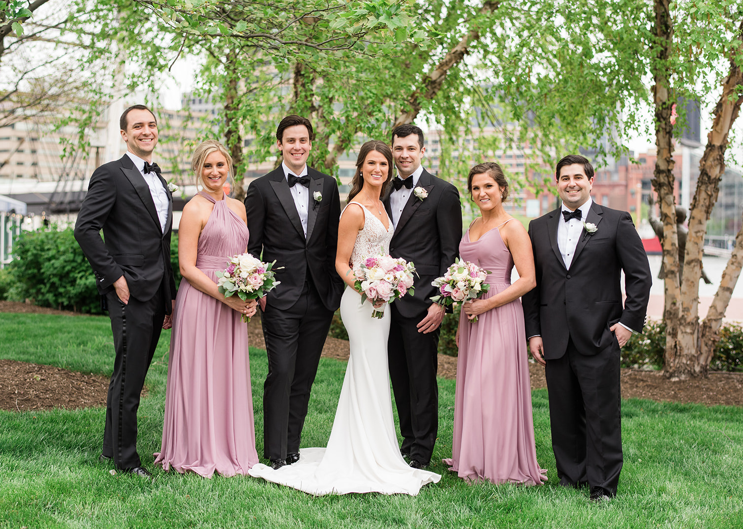 bride and groom stand with their wedding party