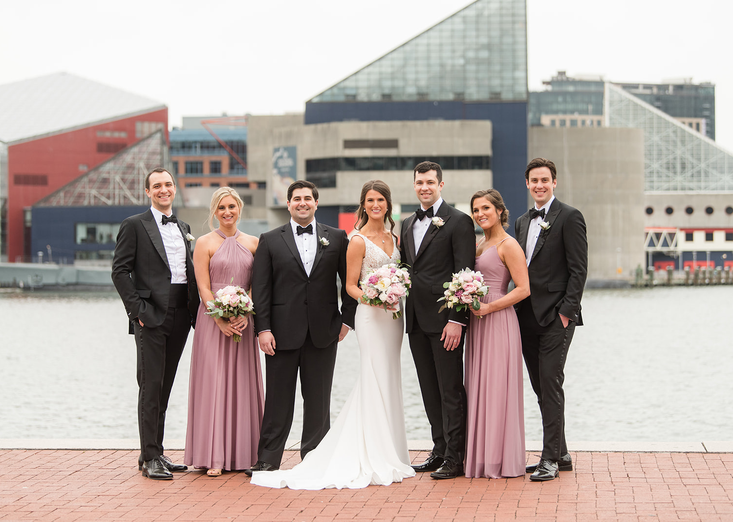 bride and groom stand with their wedding party