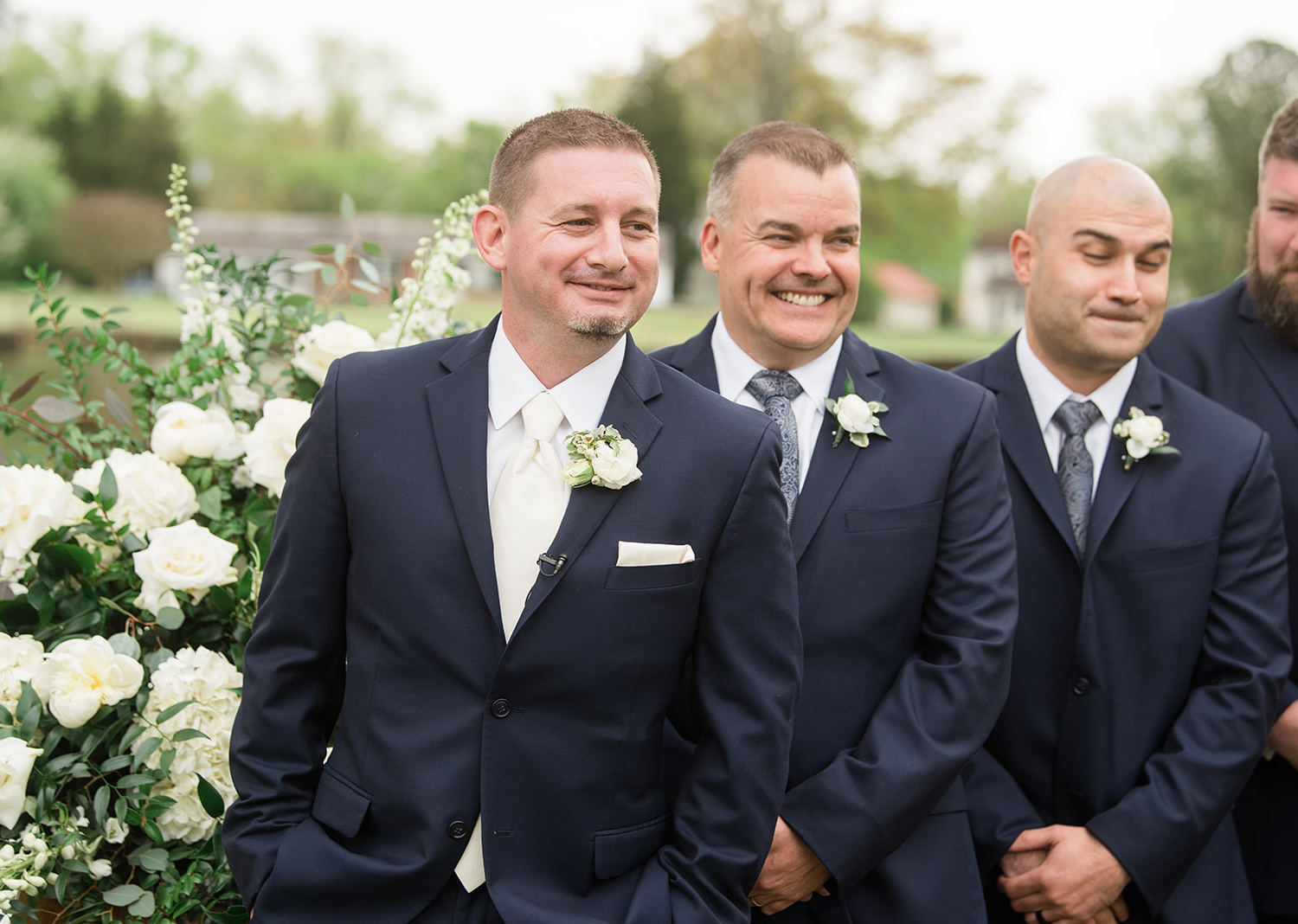 groom smiles as he waits for his bride