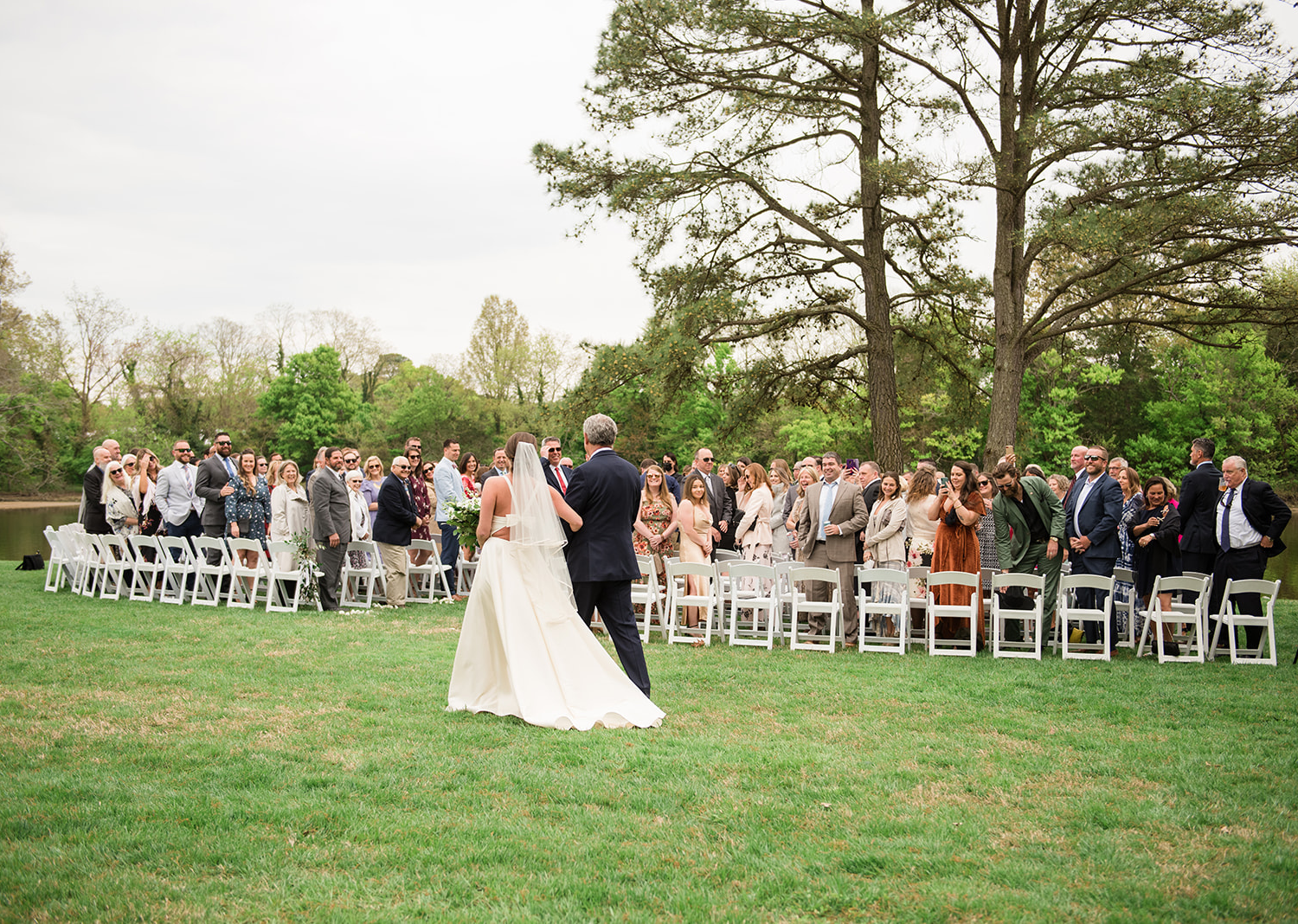 bride walks down the aisle with her father