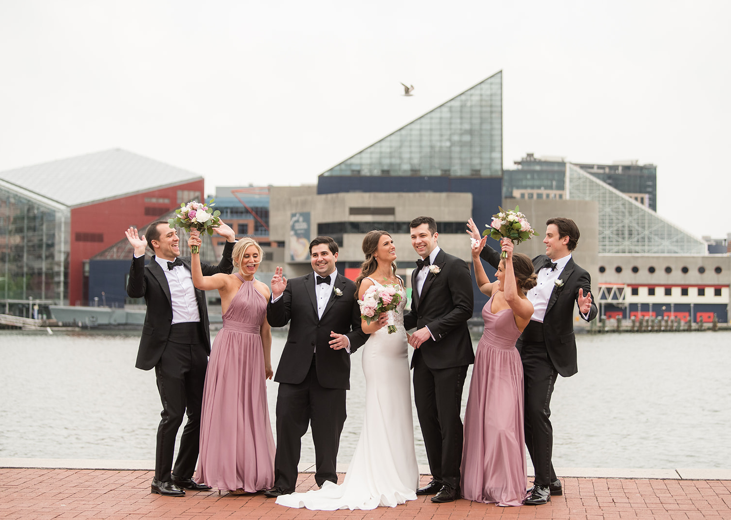 bride and groom stand with their wedding party