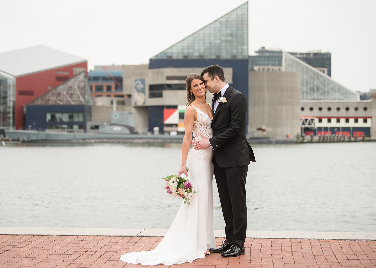 bride and groom wedding day portraits in front of a lake