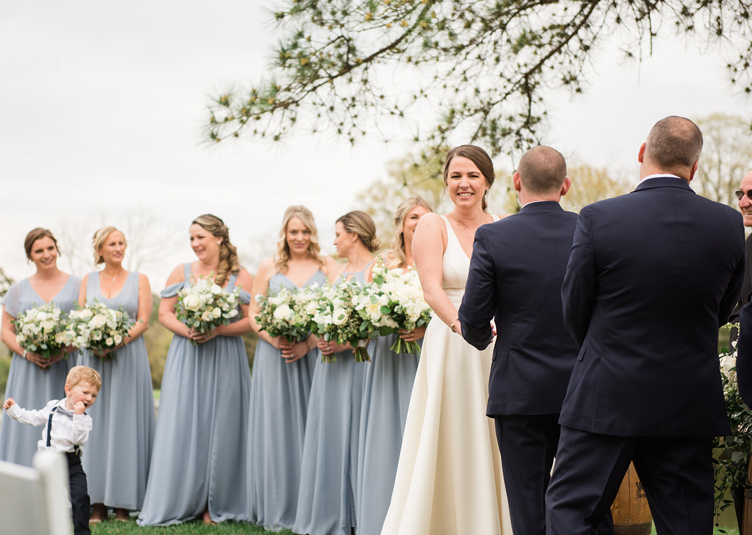 bride and groom hold hands as they start to hear their wedding speech