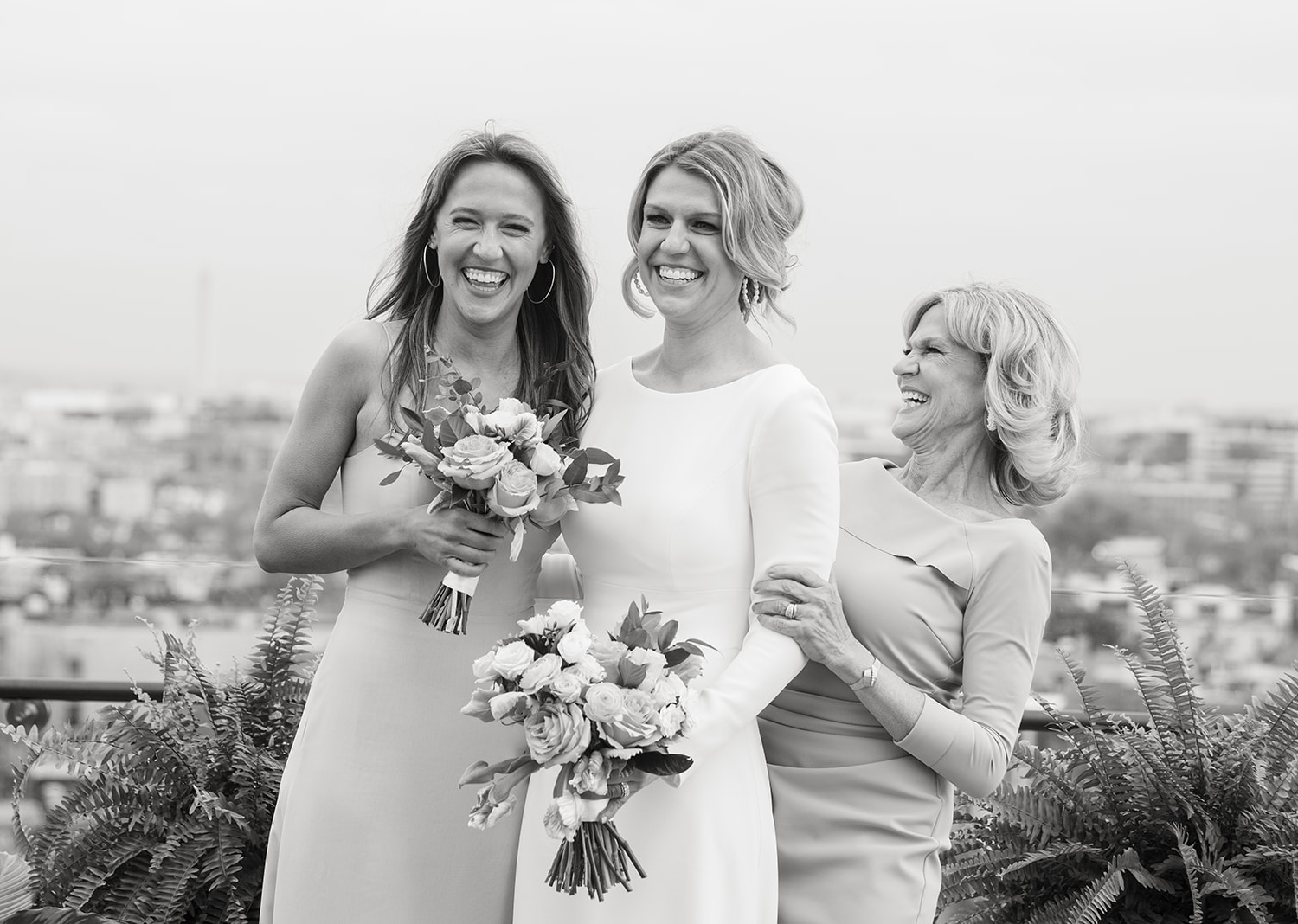 bride posing with her family on her wedding day on the rooftop of the Line hotel in Washington