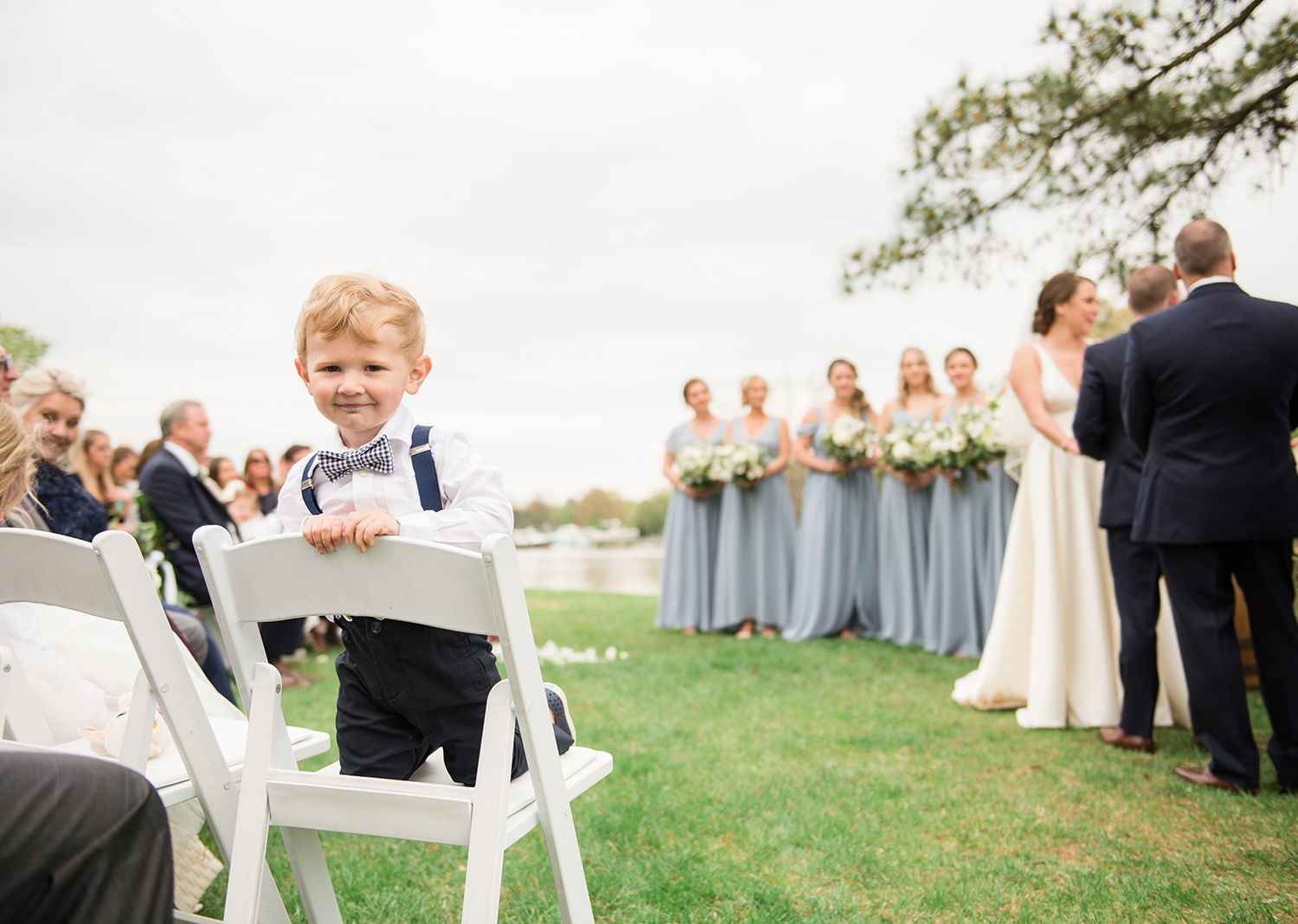 baby groomsmen smiles at the camera