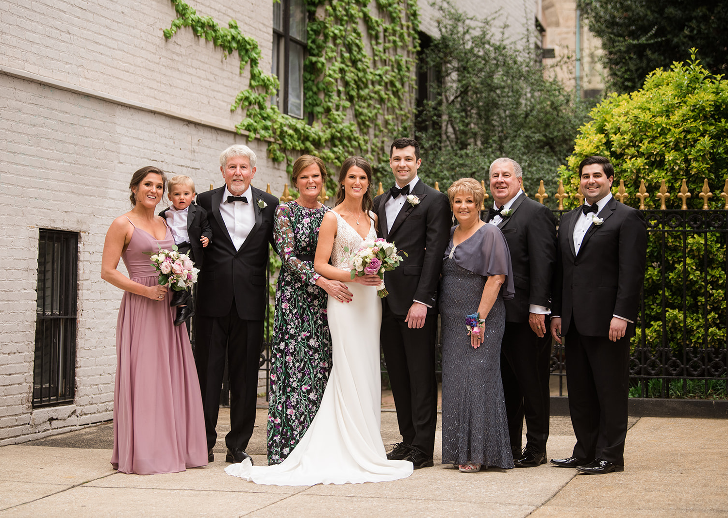 bride and groom stand with their wedding party