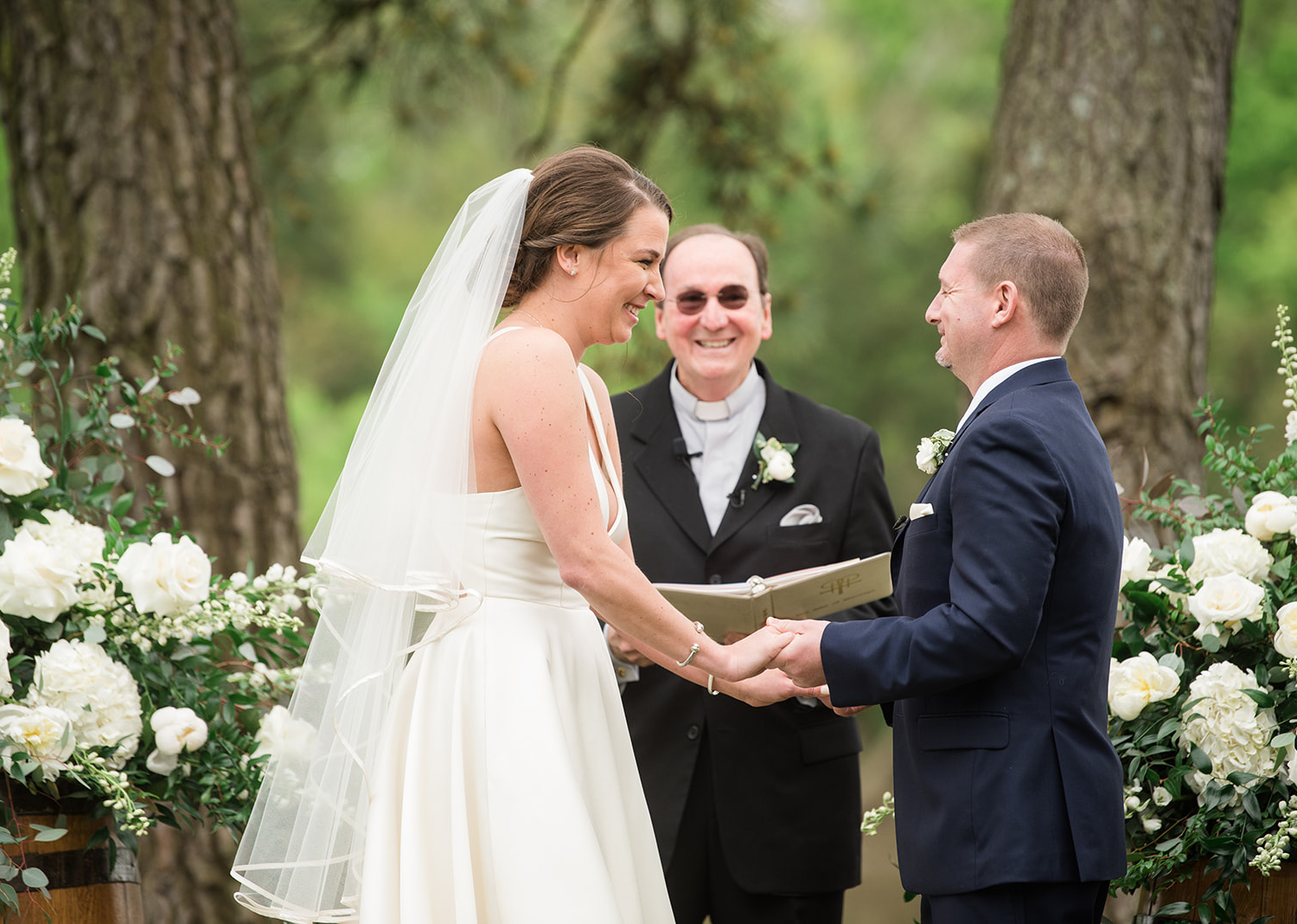 bride and groom smile during their wedding ceremony