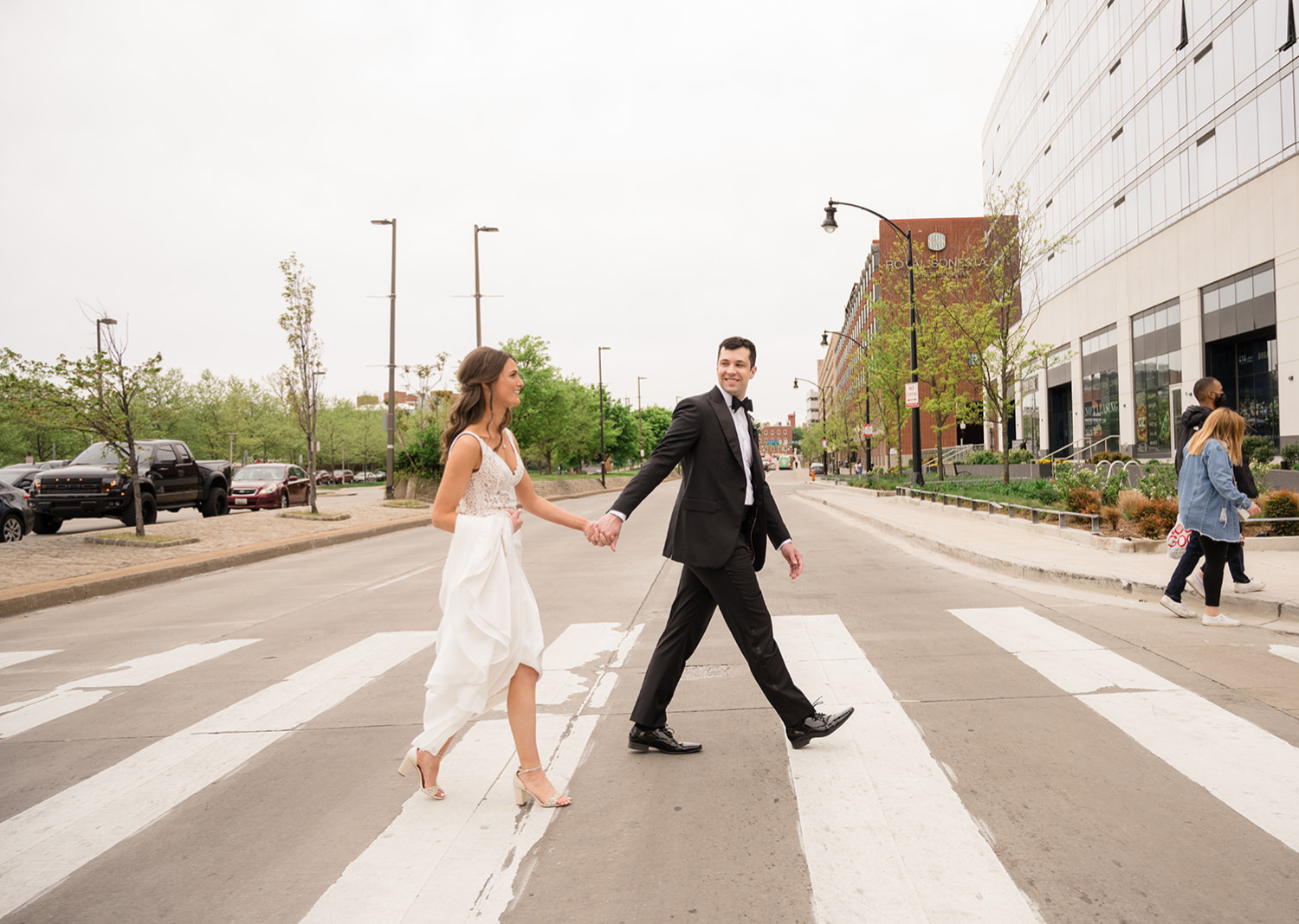 bride and groom cross the street of the Belvedere Hotel