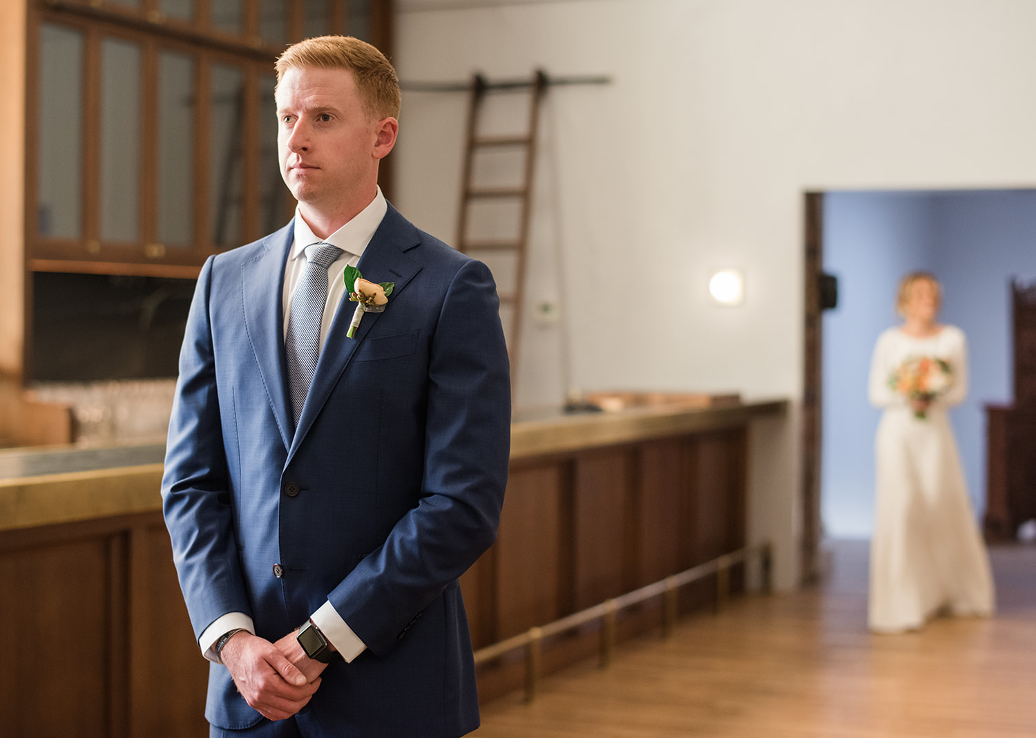 groom waiting to see his bride for their first look