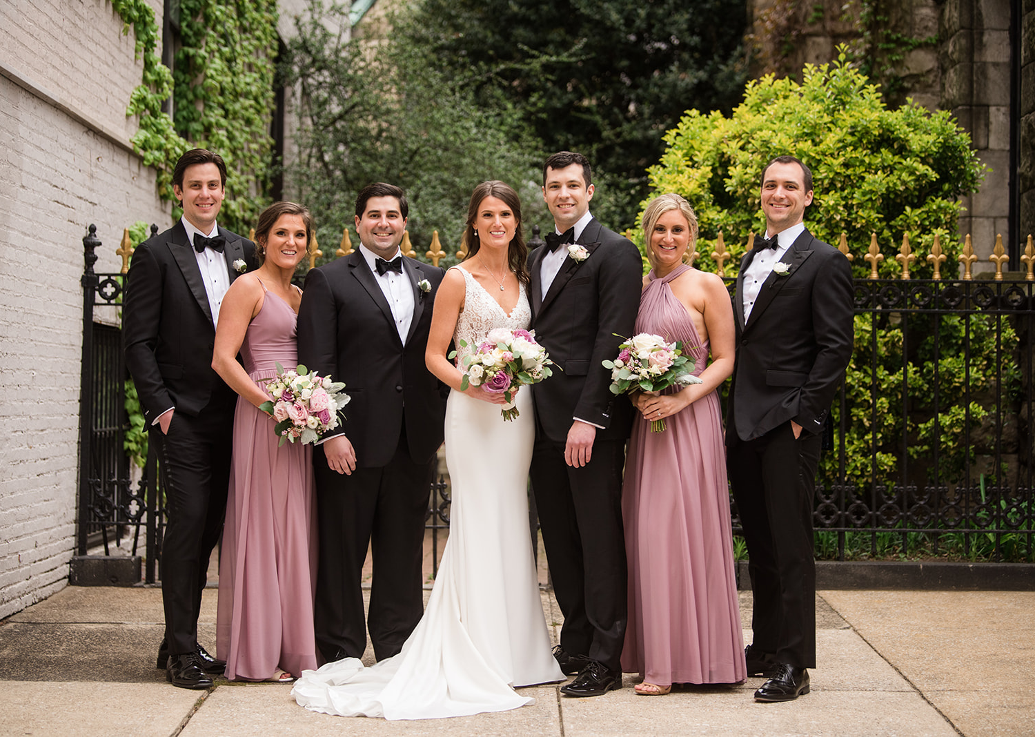 bride and groom stand with their wedding party