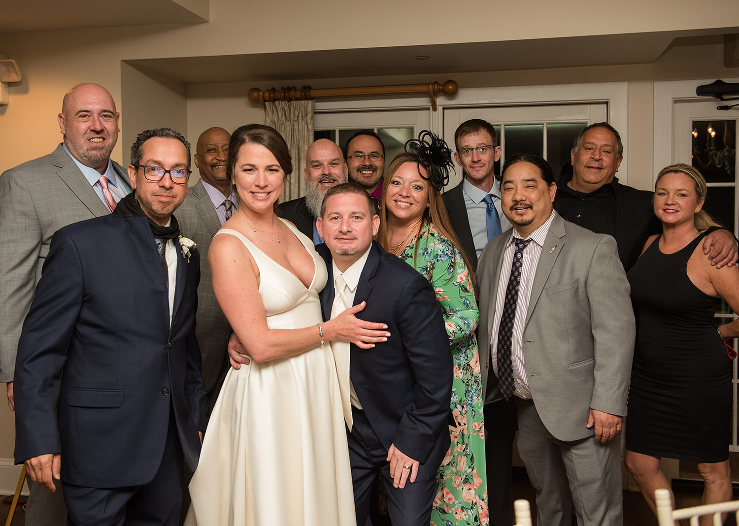 bride and groom smiling with their wedding guests