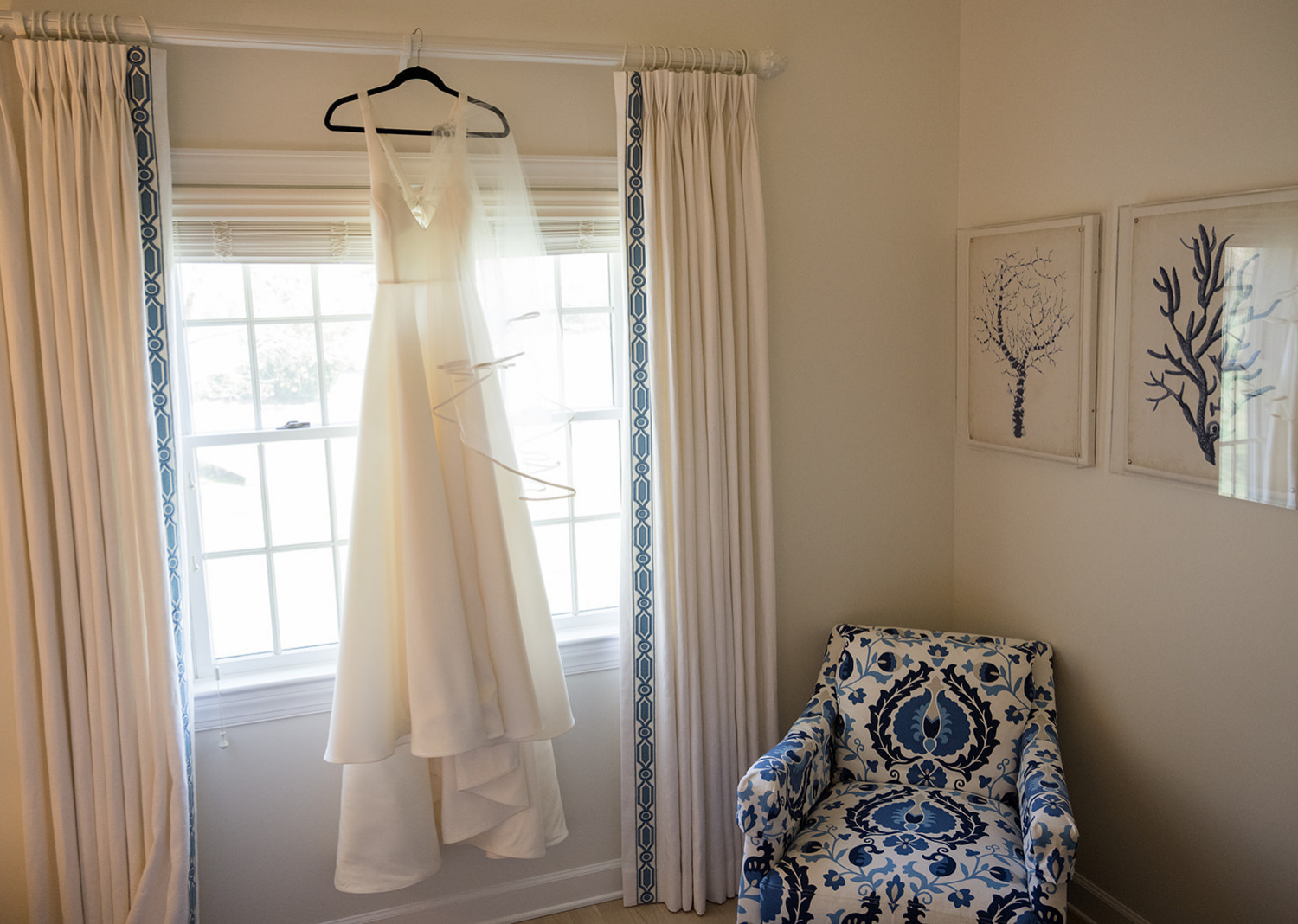 wedding dress hanging on a window