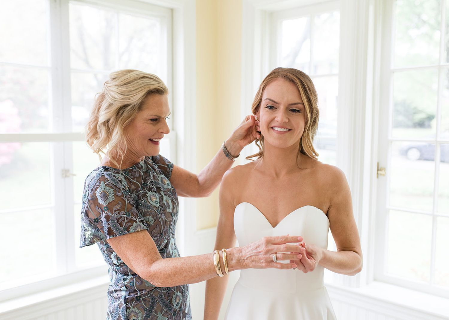 mother of the bride helping bride getting ready