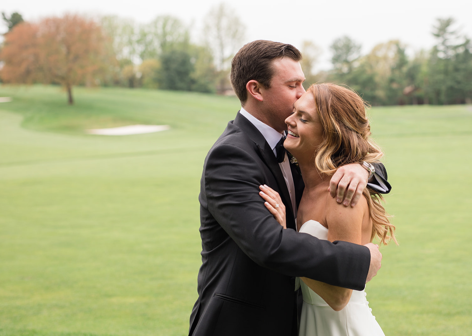 groom hugs his bride as he sees her for the first time in her wedding dress 