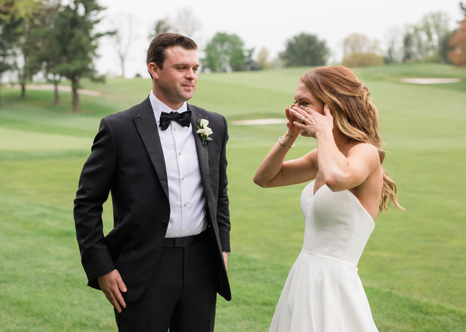 bride wipes away happy tears as she sees her groom