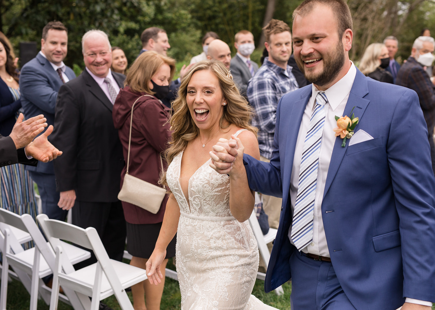 bride and groom walking down the aisle after their wedding ceremony