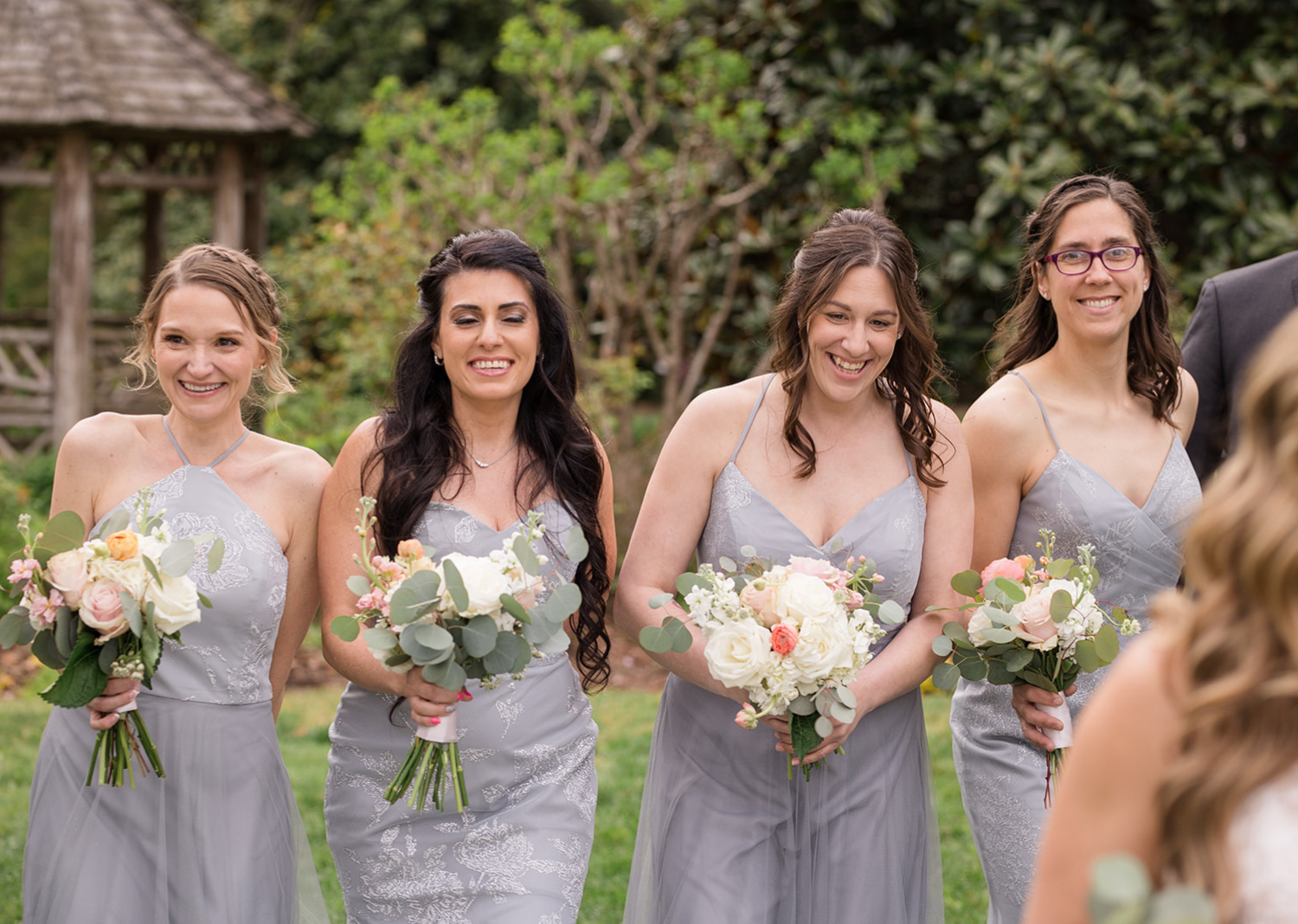 bridesmaids smiling as they look at the bride