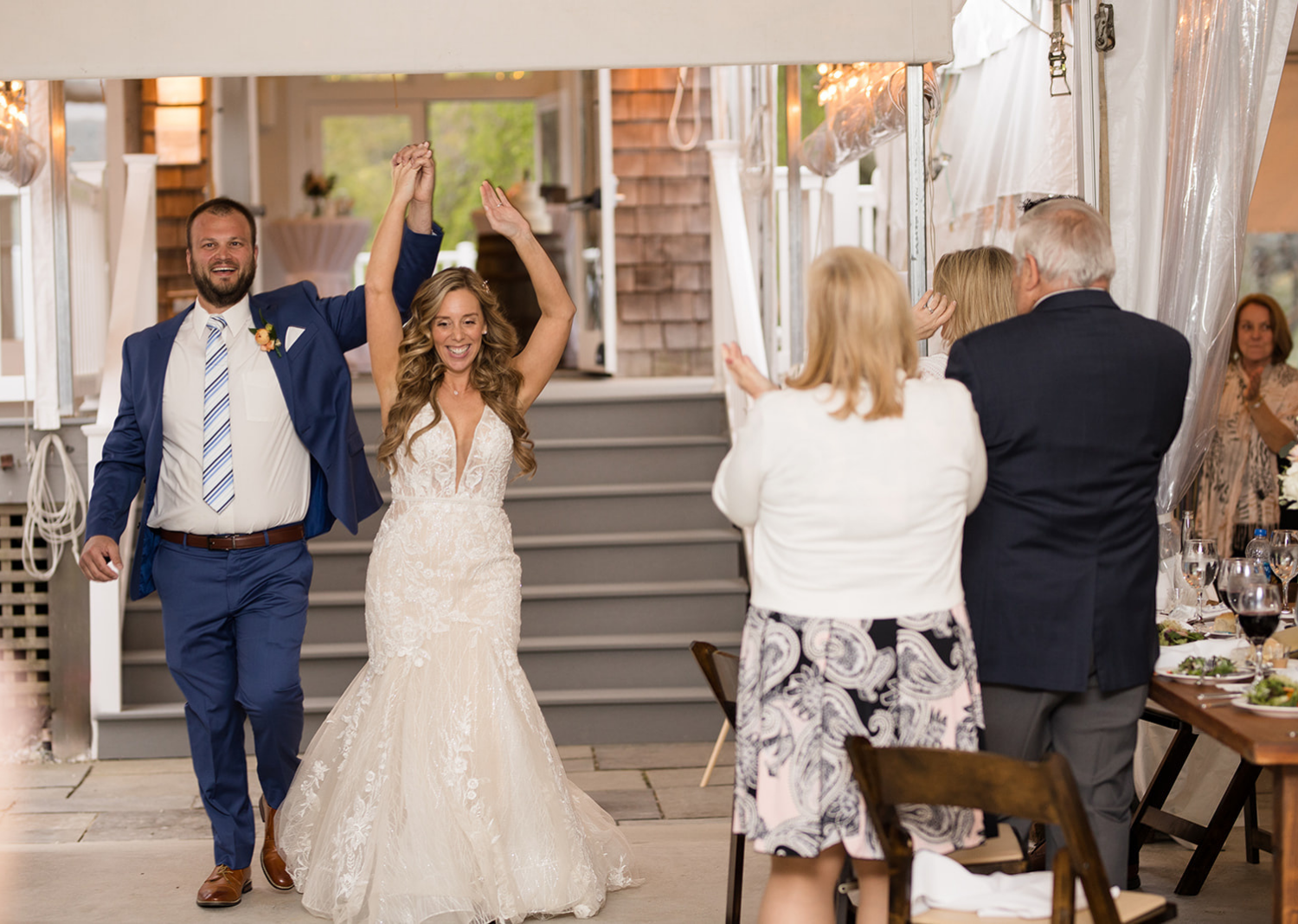 bride and groom make their first entrance to their wedding reception as husband and wife 