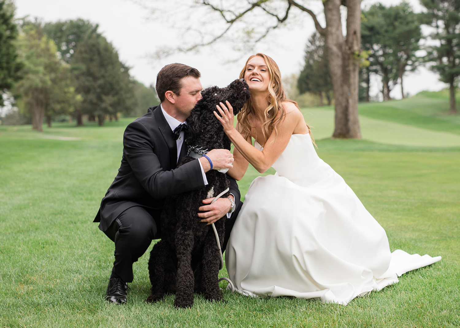 bride and groom with their dog 