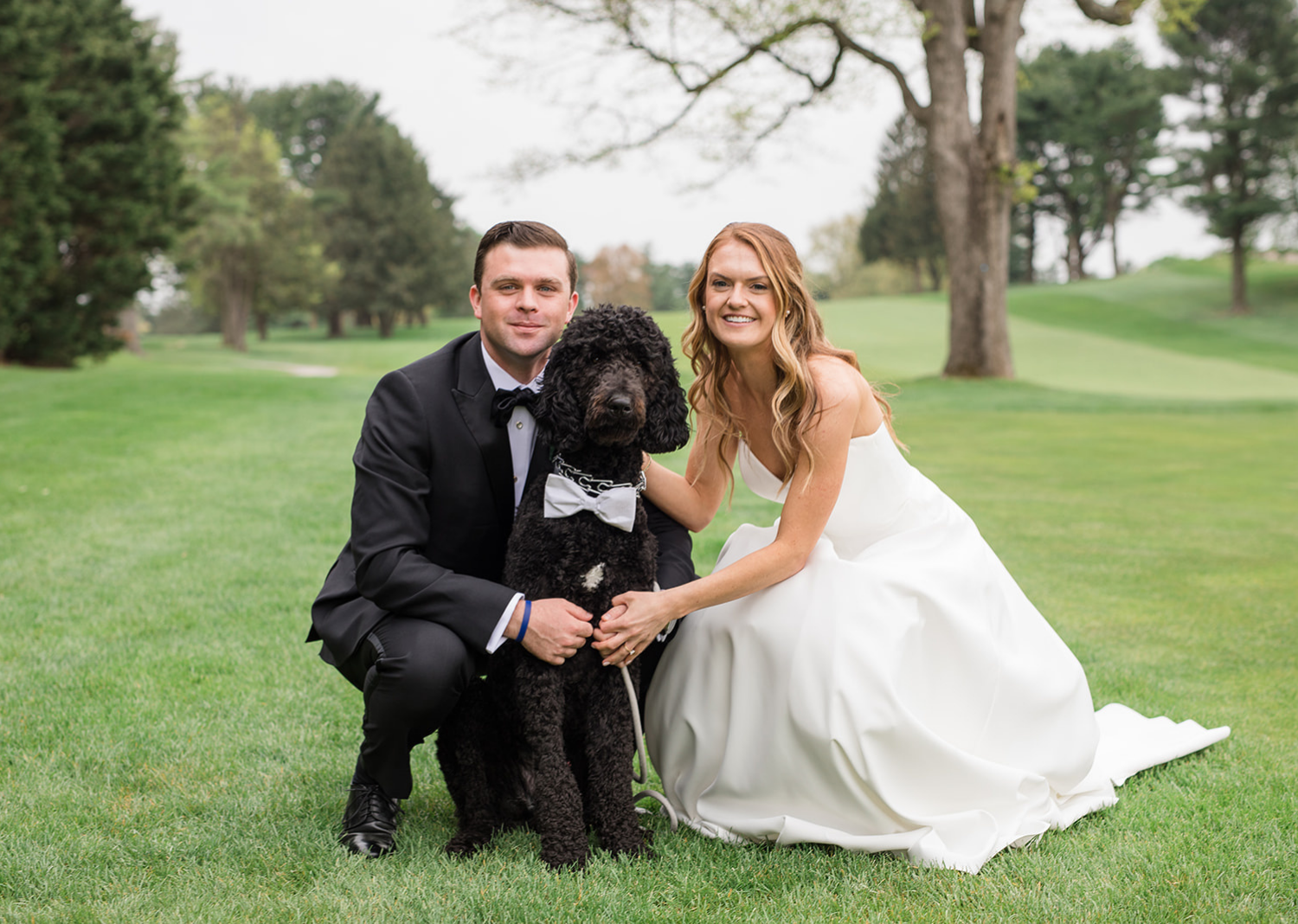 bride and groom with their dog 