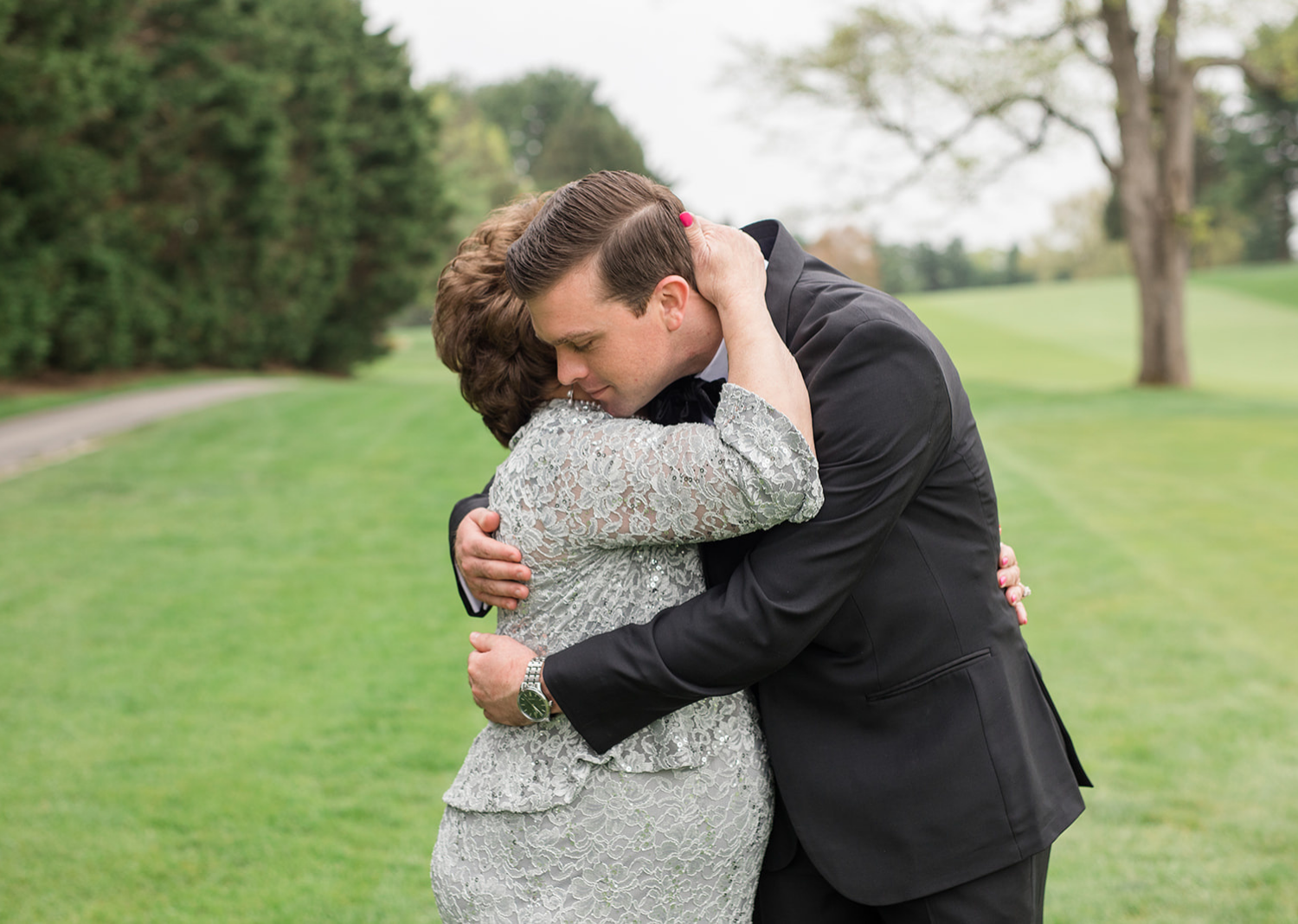 groom and mother of the groom sharing a hug 