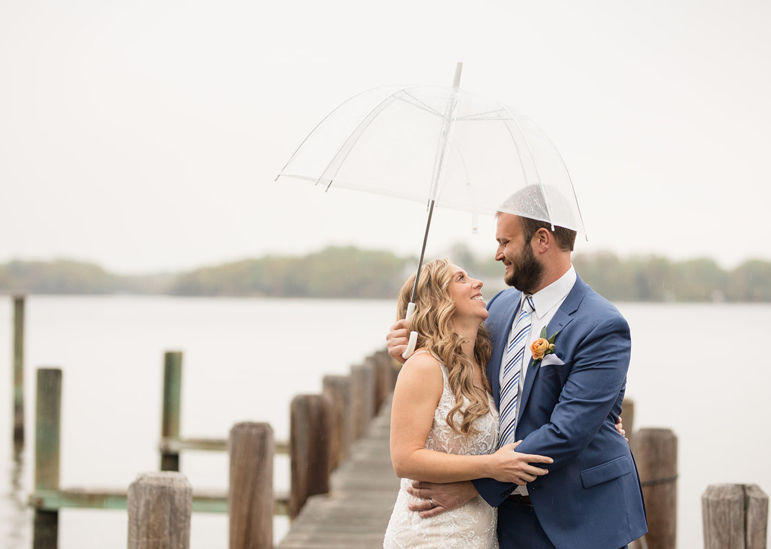 outdoor wedding portraits of the bride and the groom on a rainy deck