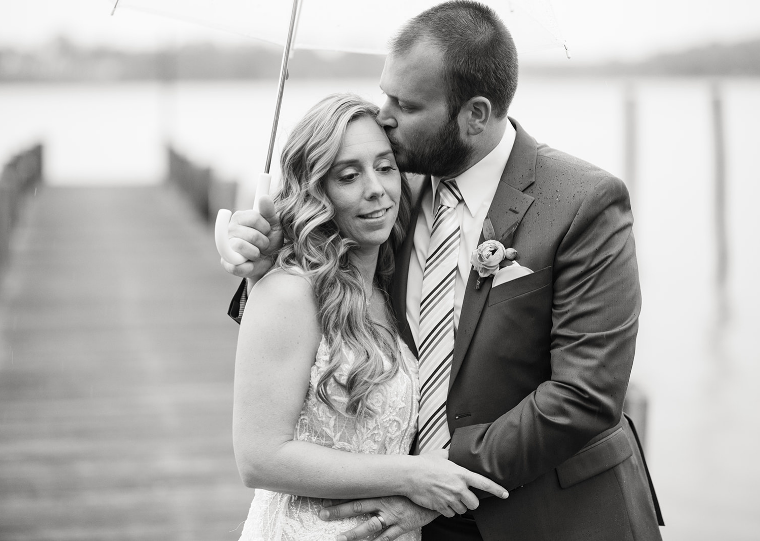 outdoor wedding portraits of the bride and the groom on a rainy deck