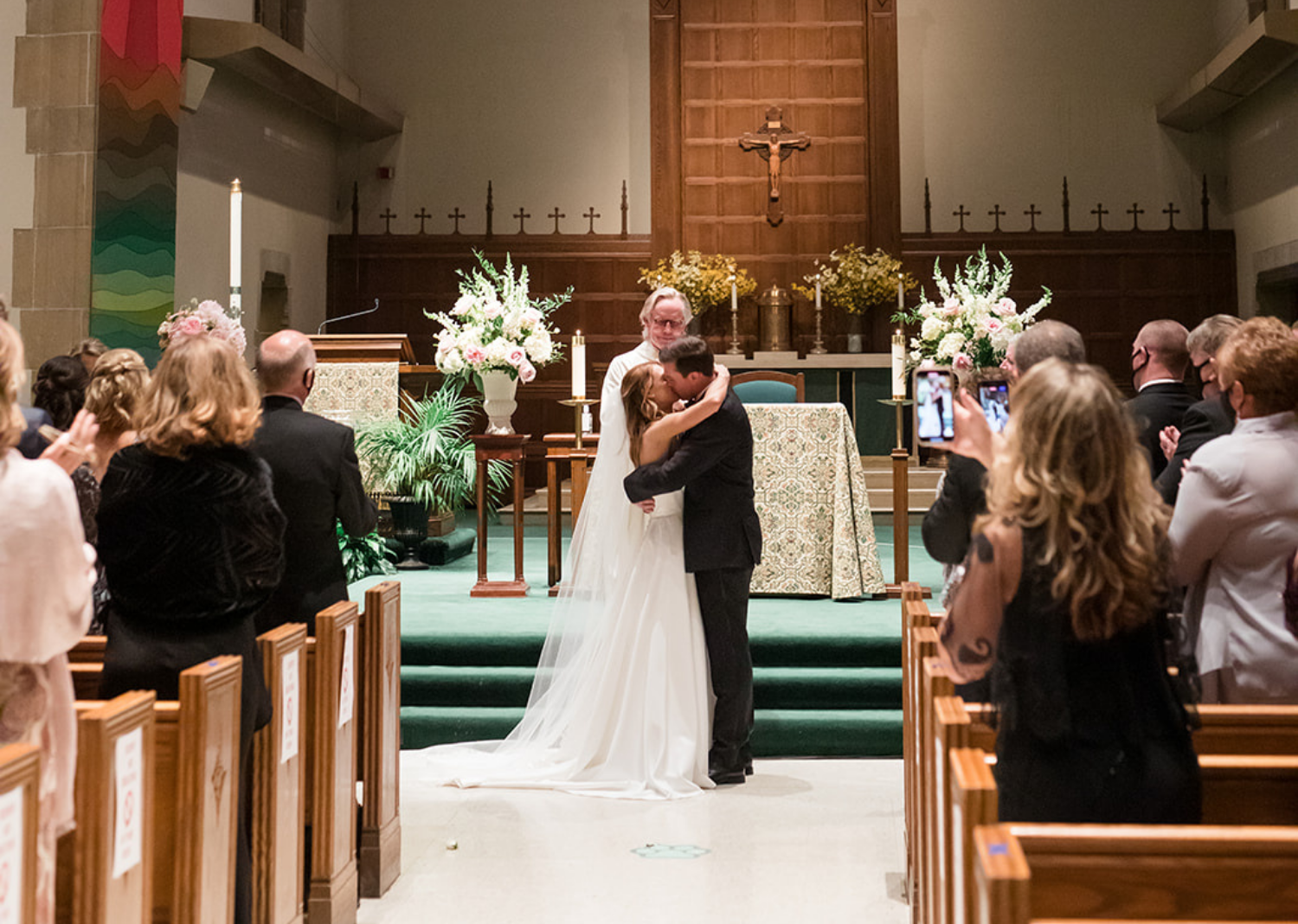 bride and groom share their first kiss as husband and wife 