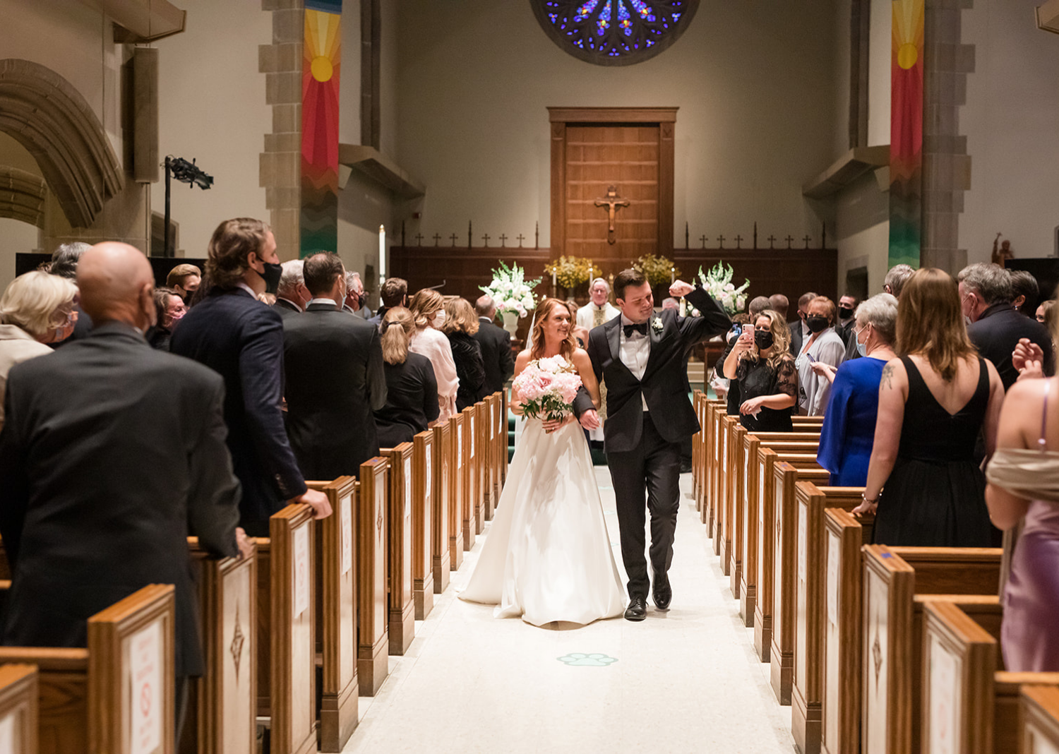 bride and groom walking down the aisle after their wedding ceremony 