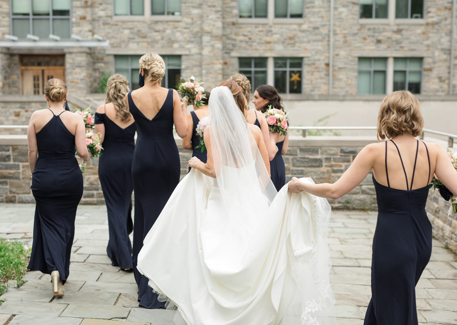 bride and bridesmaids walking over to the wedding reception 