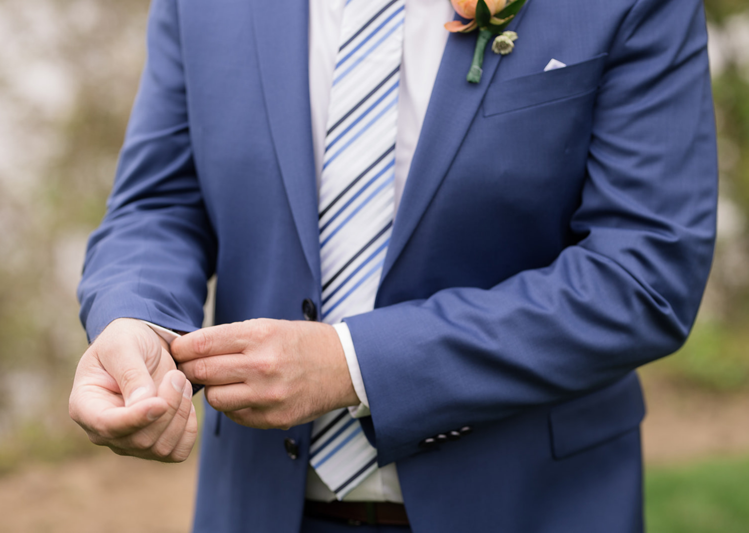 groom fixing his cufflinks