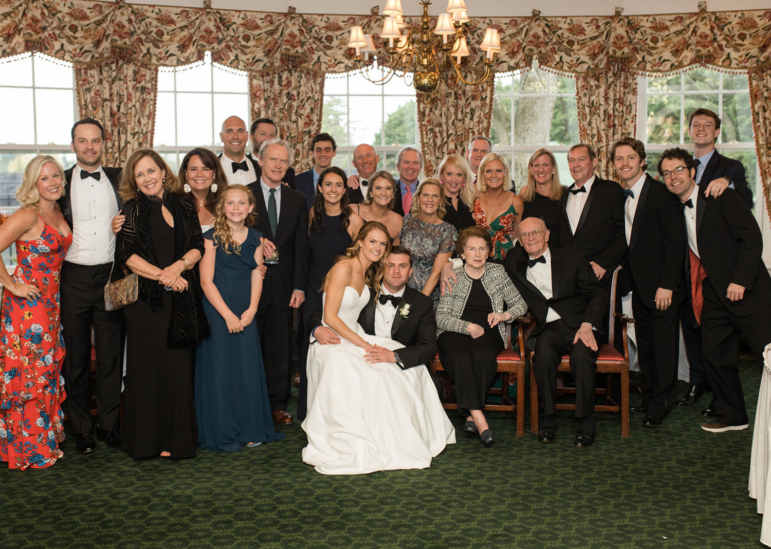 bride and groom with their family during the wedding reception