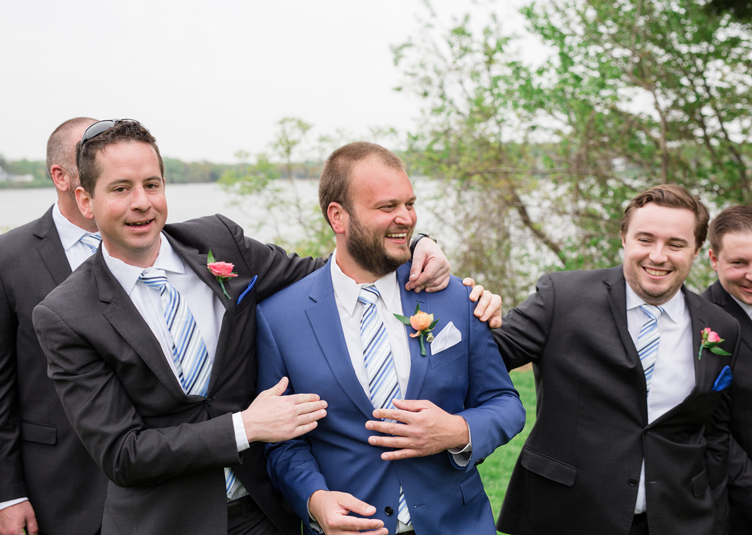 groom laughing with his groomsmen 