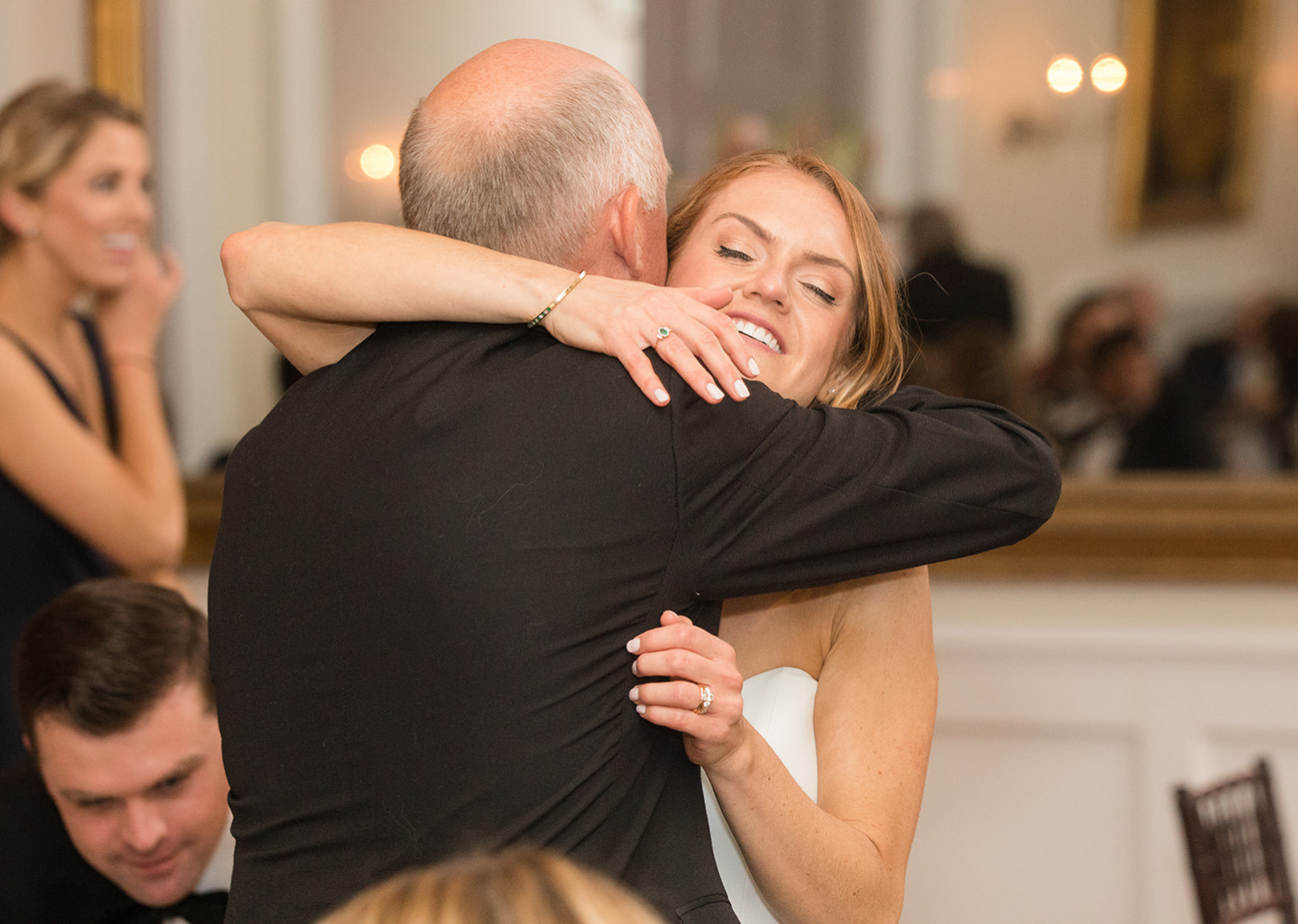 bride and her father share a hug