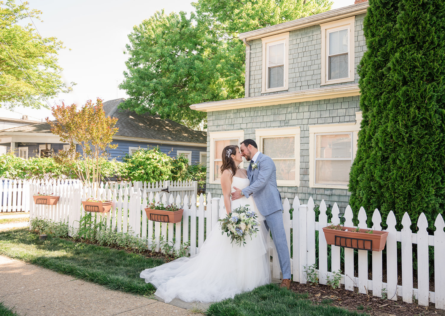 outdoor bride and groom portraits - bride and groom share a kiss