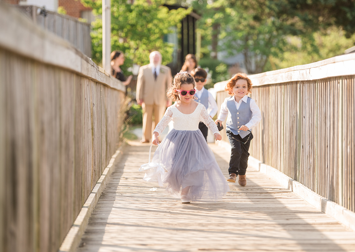 flower girl and ring boy walk down the aisle