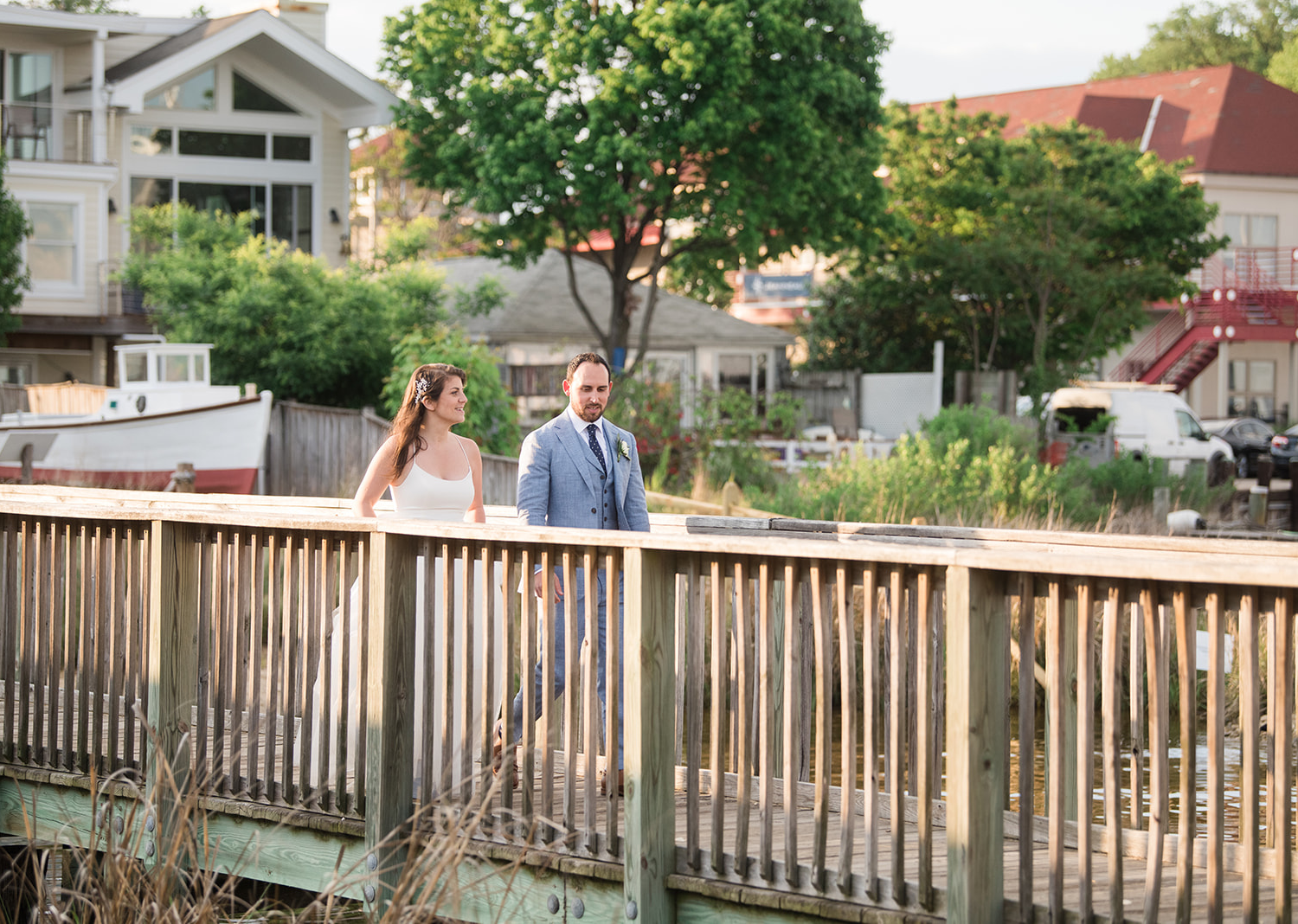 bride and groom walking down the pier