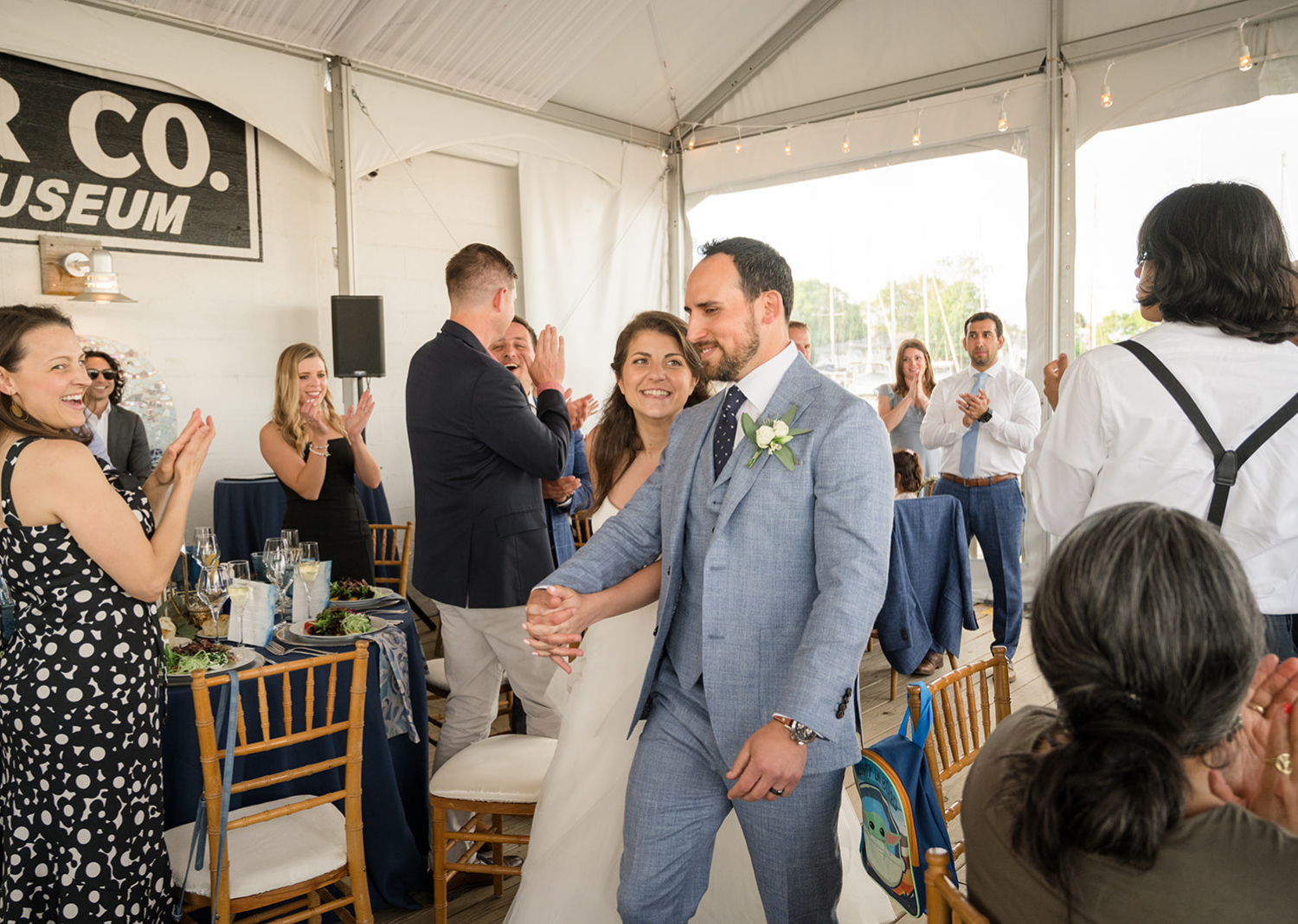 bride and groom walking into their wedding reception space