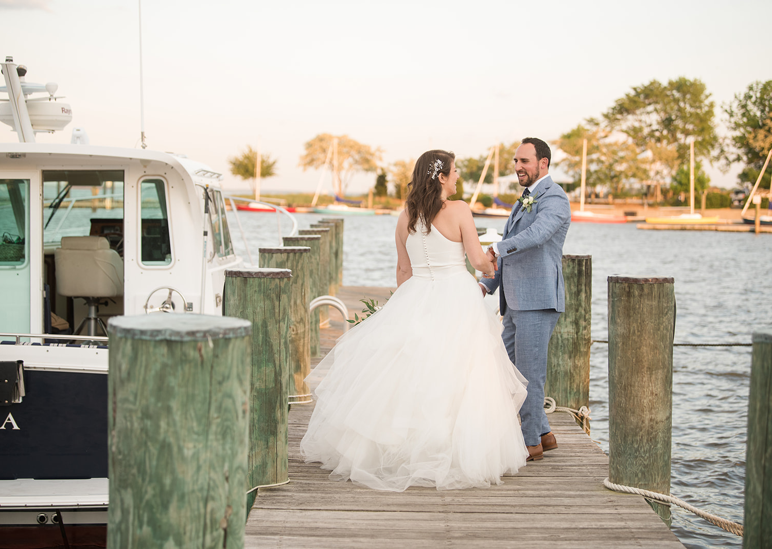 bride and groom sharing a romantic moment at the lake pier