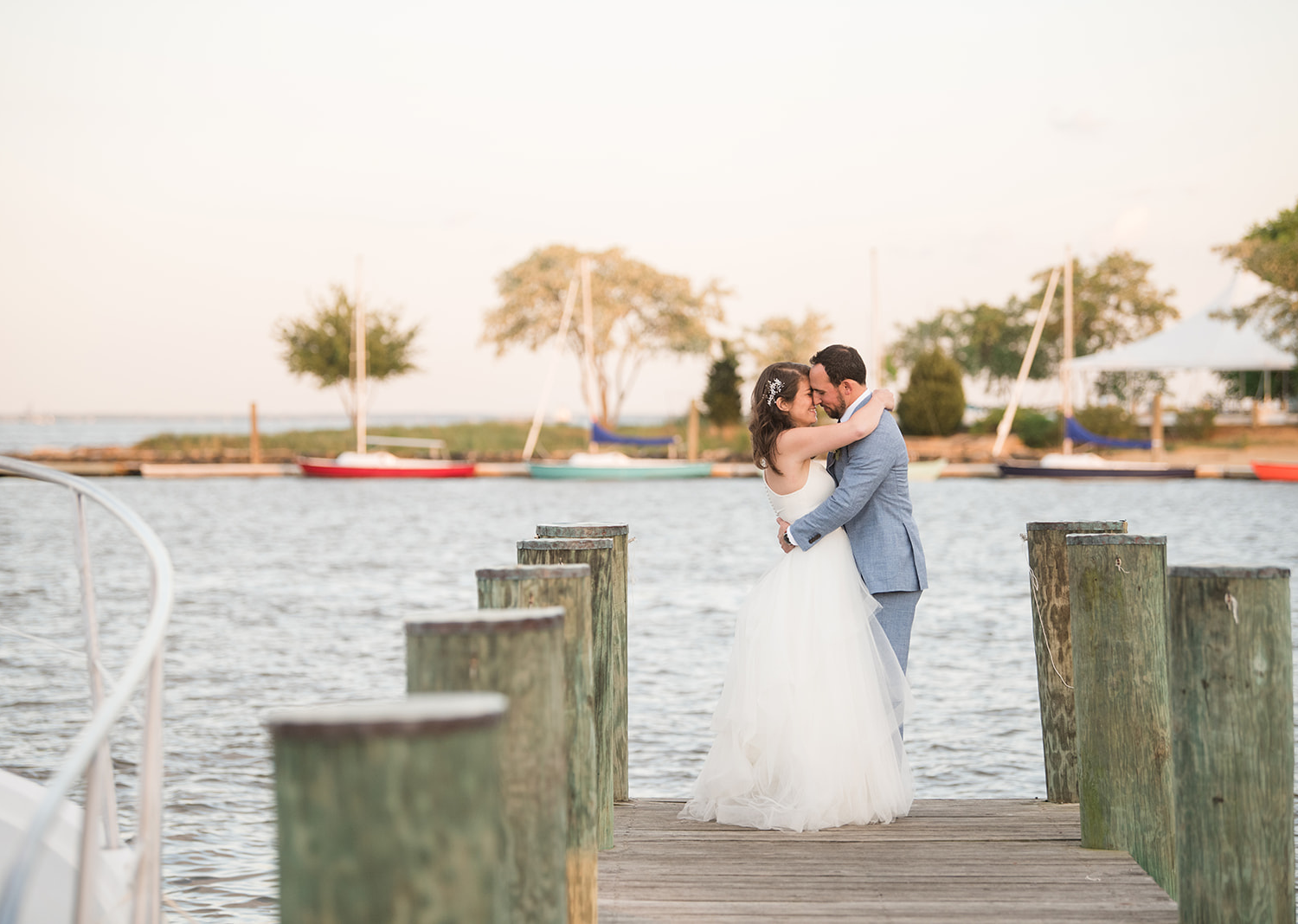 bride and groom share a kiss on the pier 