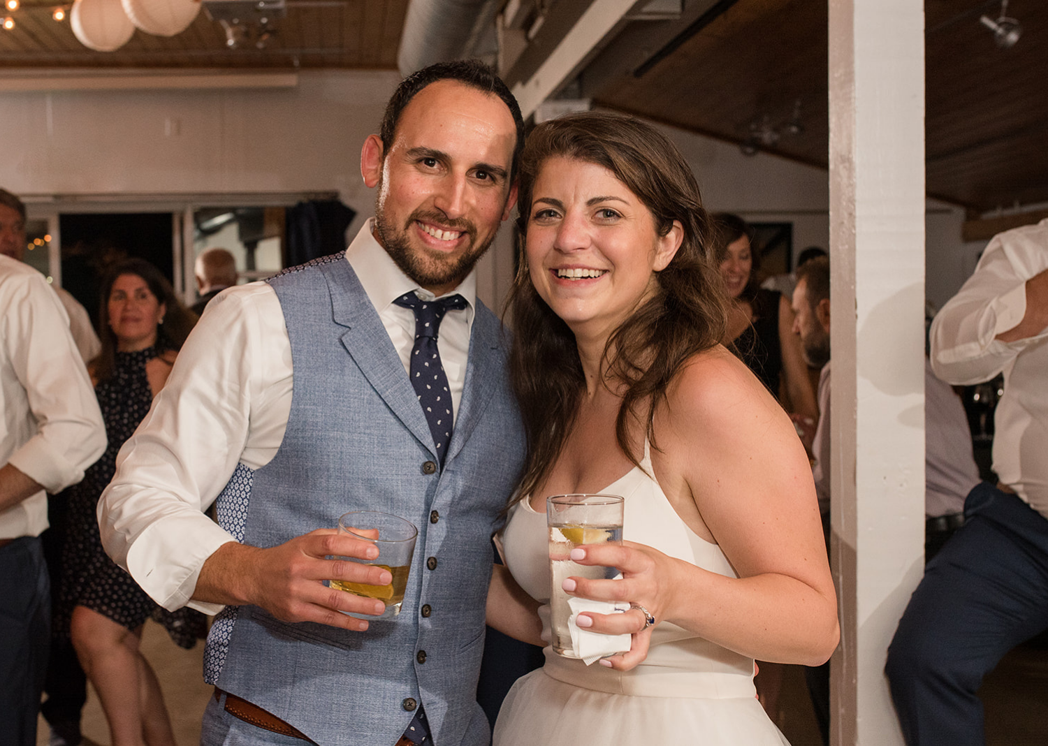 bride and groom smile during their wedding reception